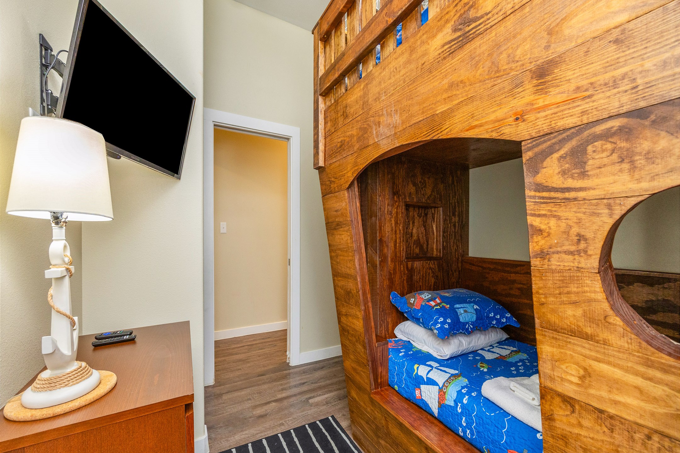 Second bedroom featuring a full-over-twin pirate ship bunk bed and a flat-screen TV for added comfort and entertainment