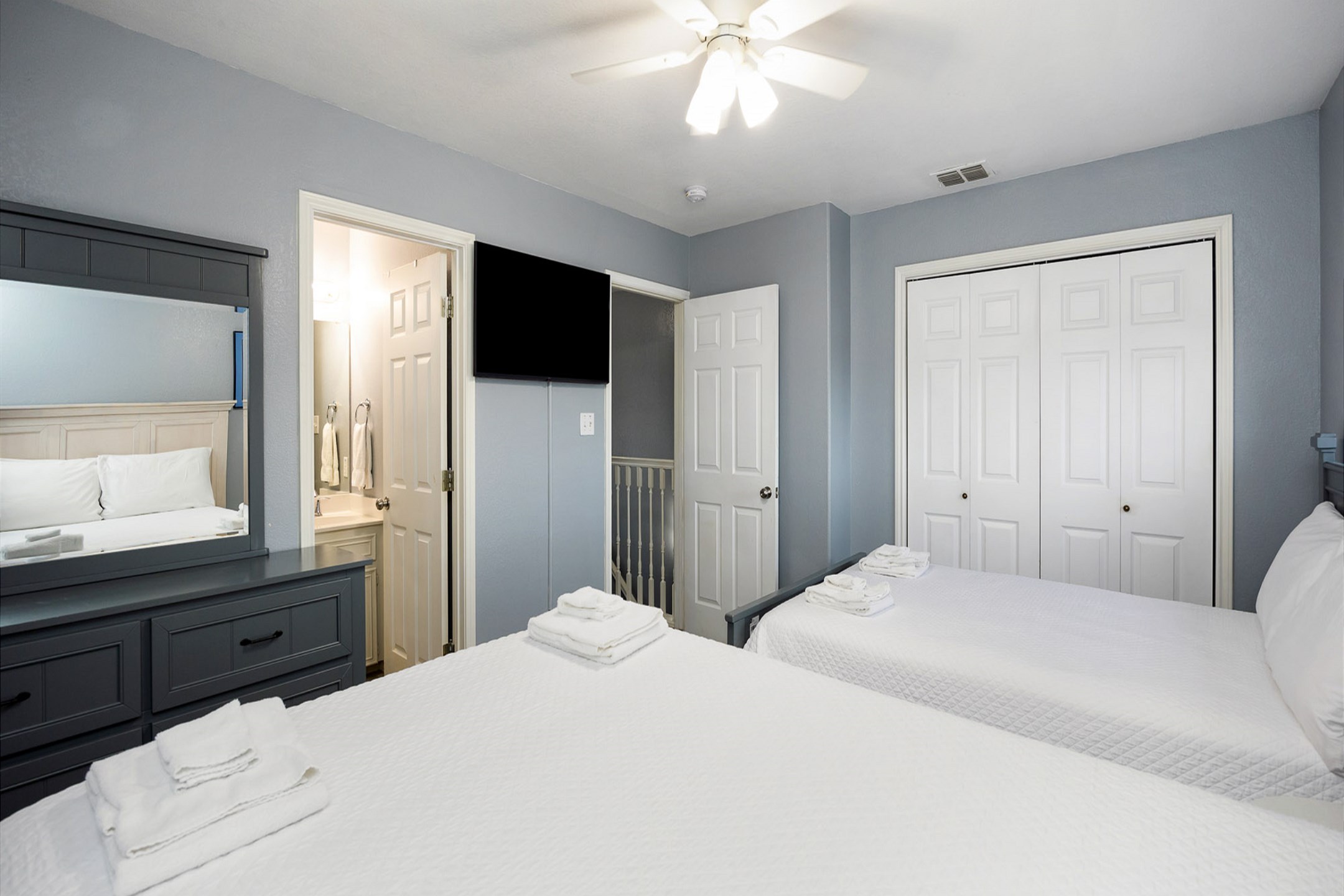 Second bedroom on the second floor with two queen size beds, private bathroom and flat screen TV 