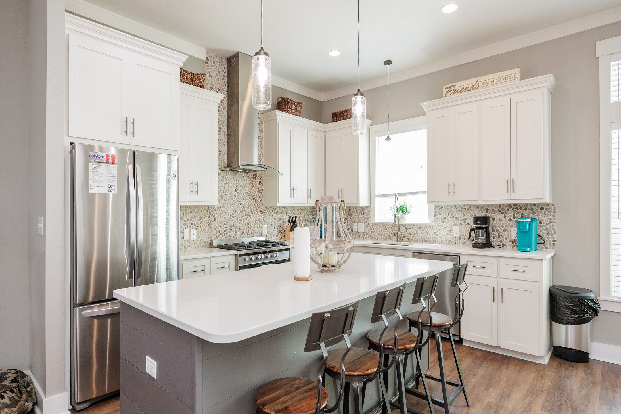 Open concept kitchen with barstools and coffee maker located on second floor 