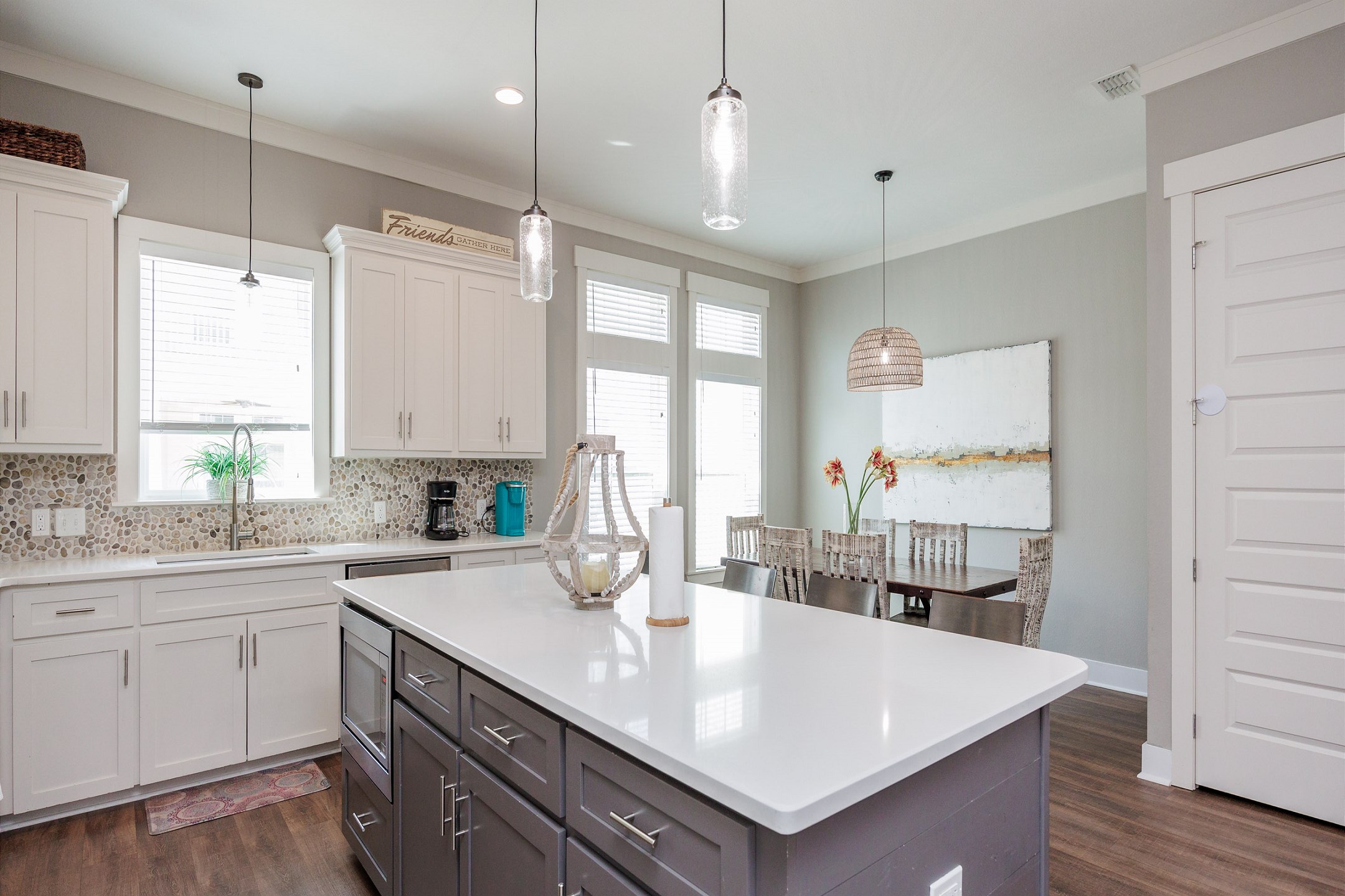 Large kitchen island opening into dining area located on second floor 