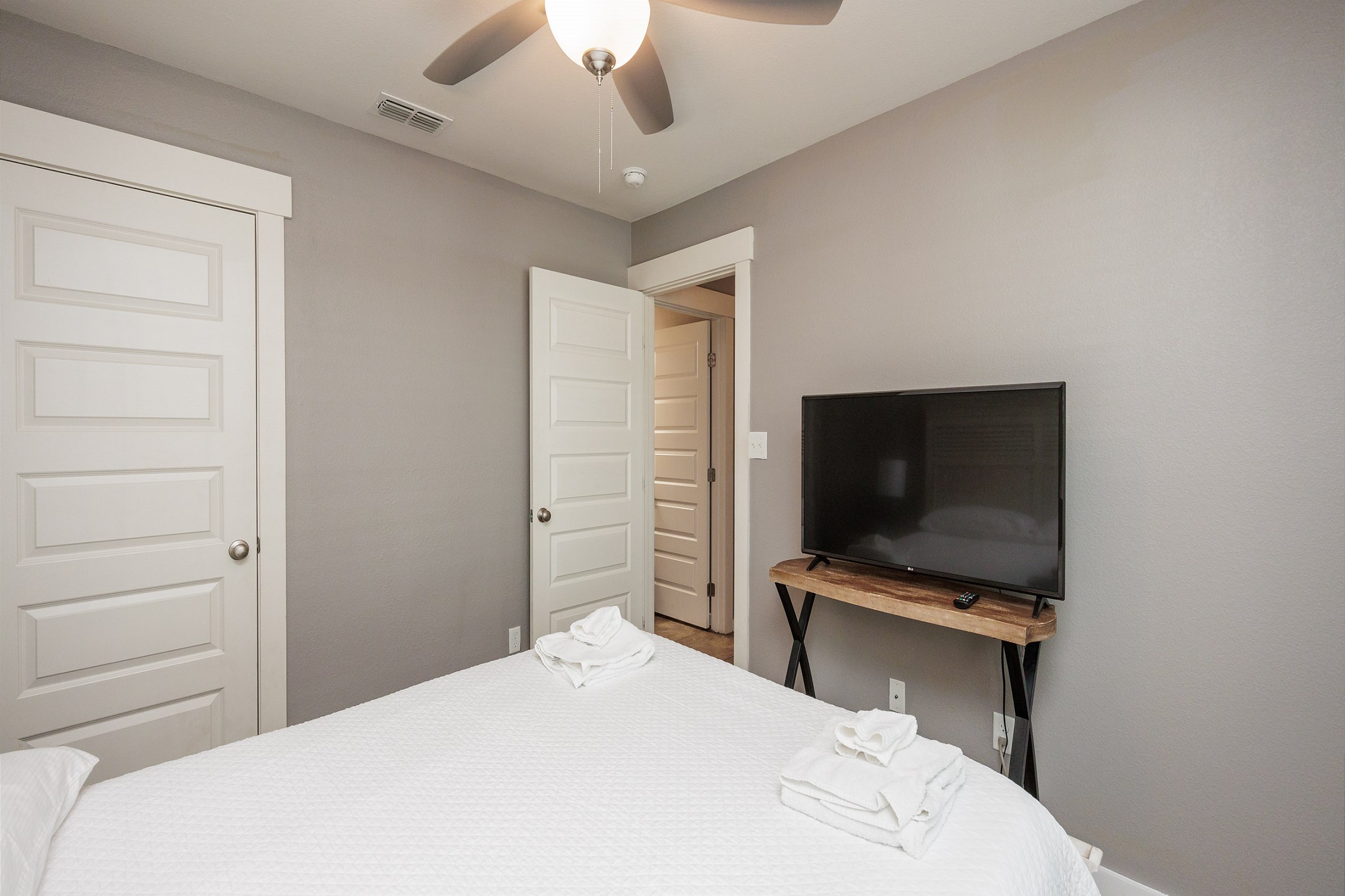 Third floor bedroom with queen size bed and TV