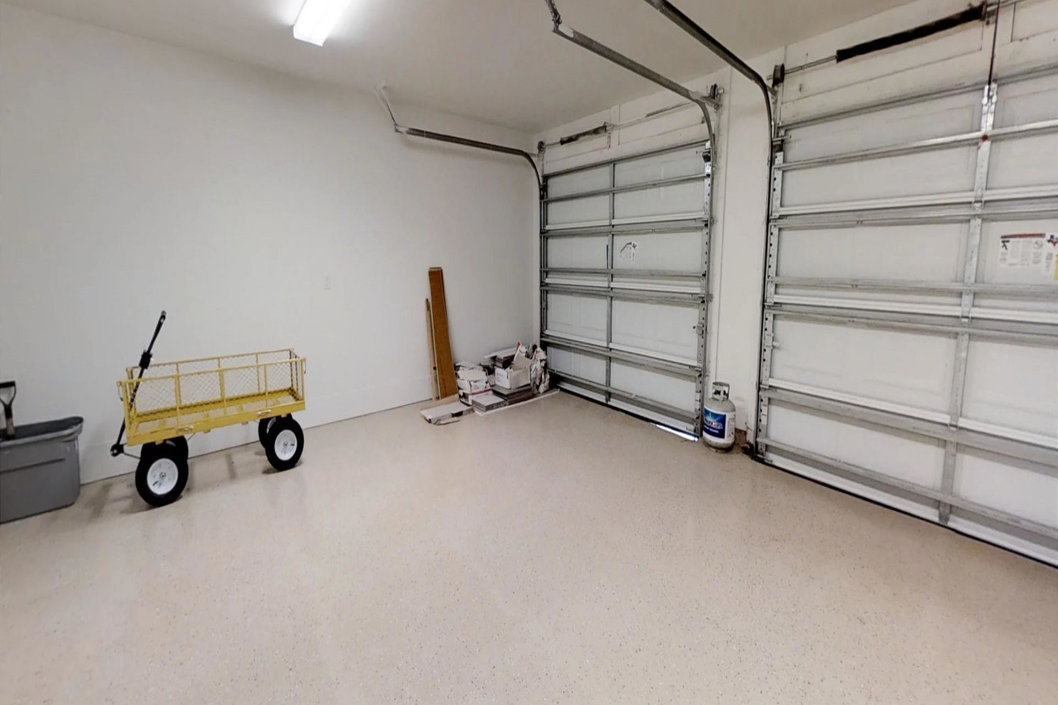 Garage access with parking for two vehicles. Please note: second garage is manual lift only