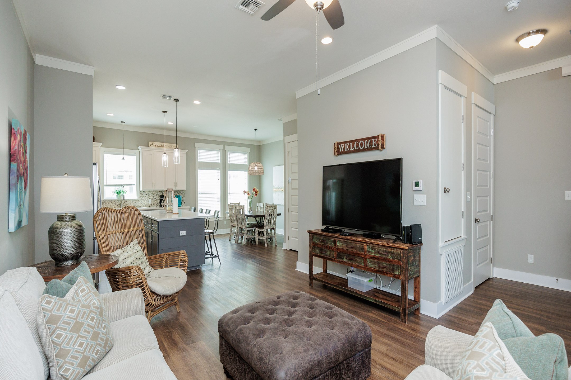 Living area with large sofa and flat screen TV located on second floor 