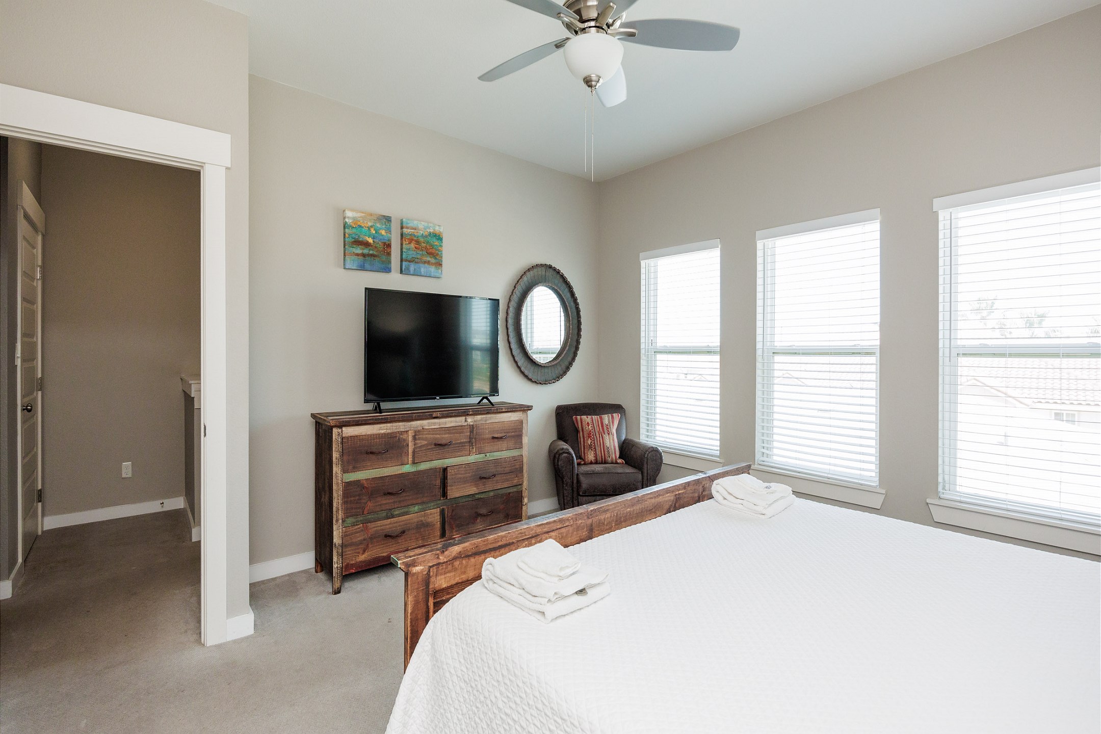 Third floor master bedroom with king size bed, TV and chair - perfect space for some R&R