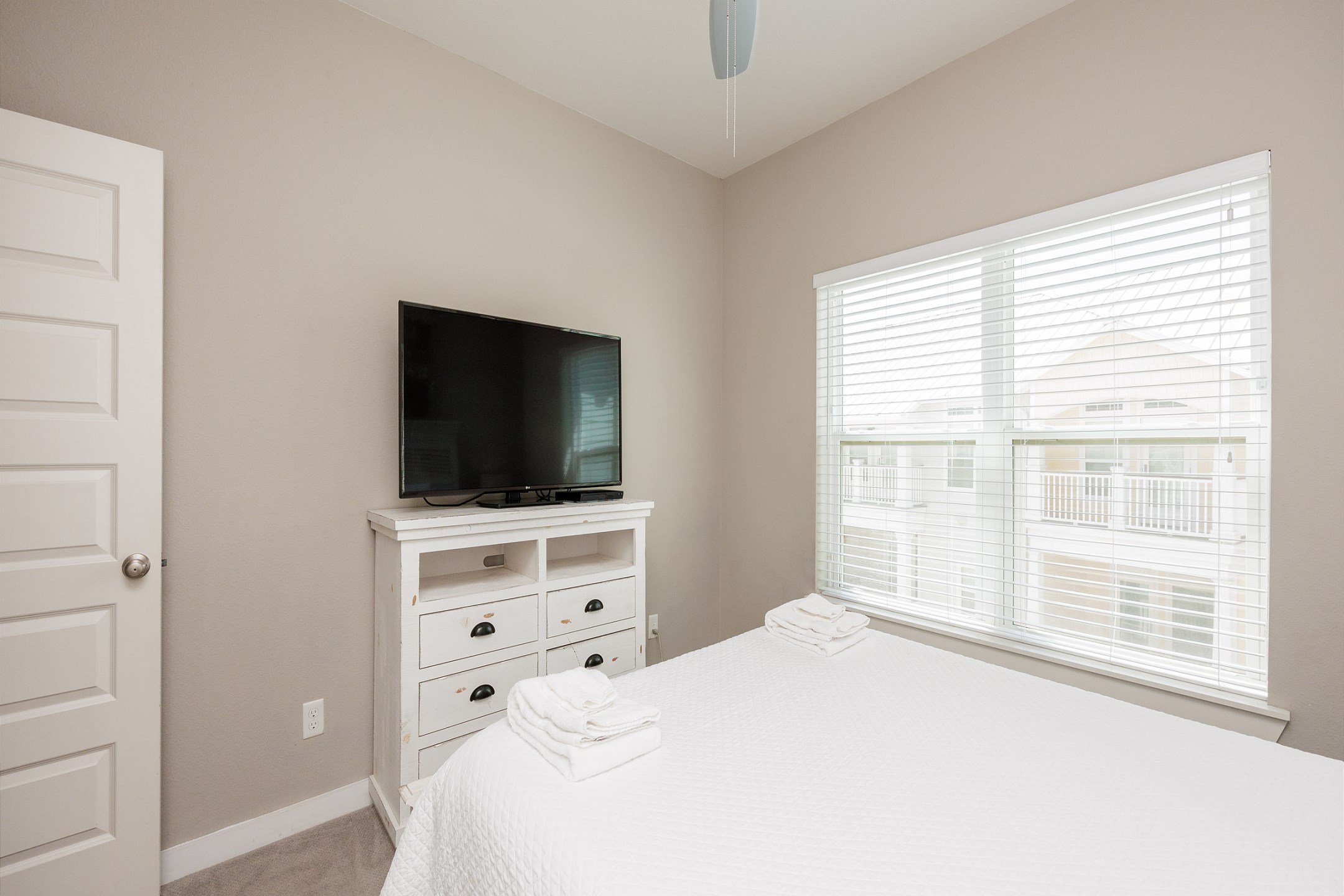 First floor bedroom with queen bed and TV