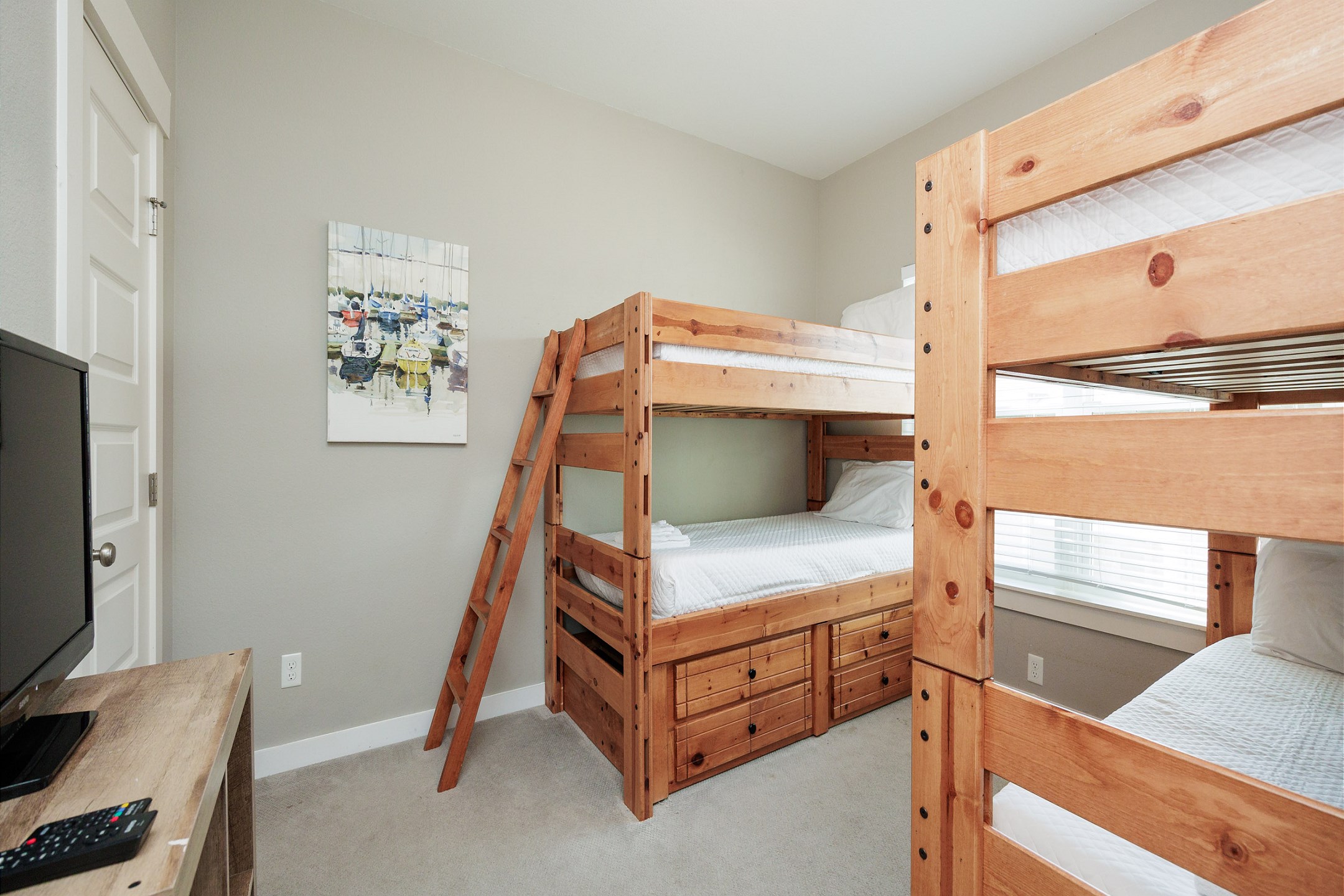 Third floor bedroom with twin over twin size bunk beds and flat screen TV