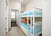 Twin size bunk beds and washer/dryer in hallway nook