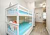 Twin size bunk beds and washer/dryer in hallway nook