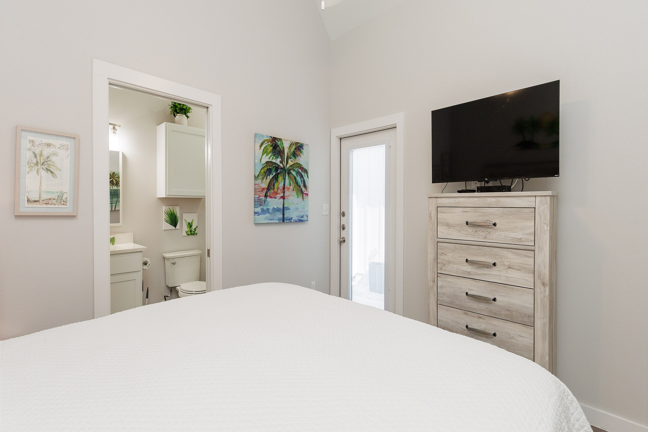 Master bedroom with a king size bed, ensuite bathroom, and flat screen TV