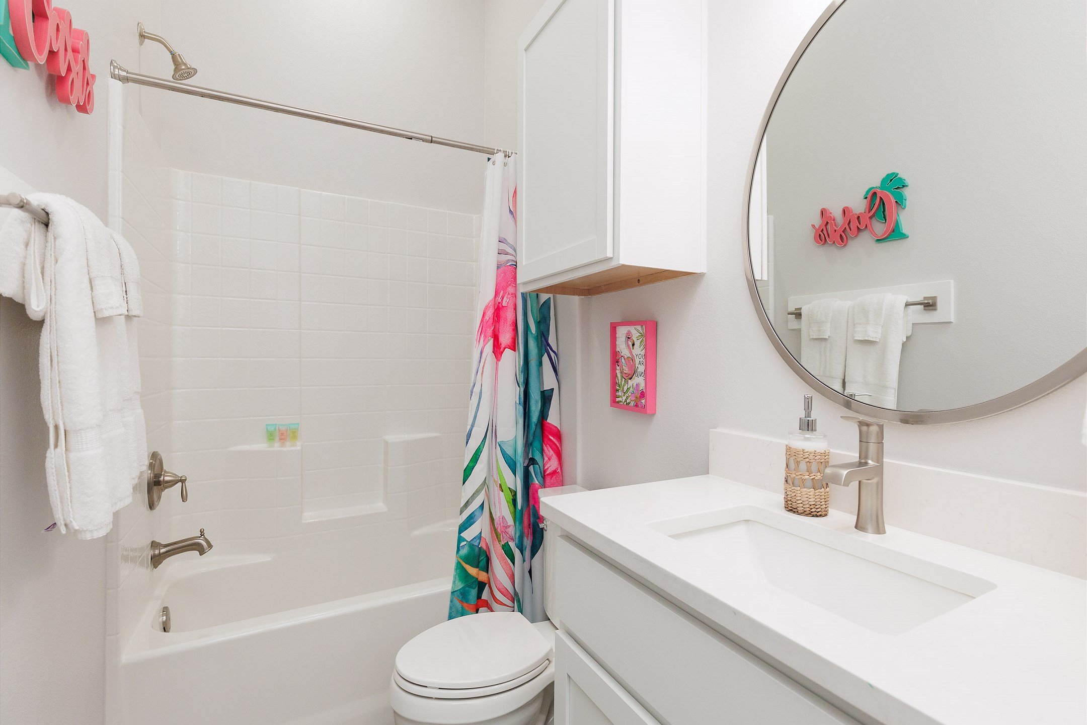 Guest bathroom off the hallway with sink, toilet, and tub/shower combo 