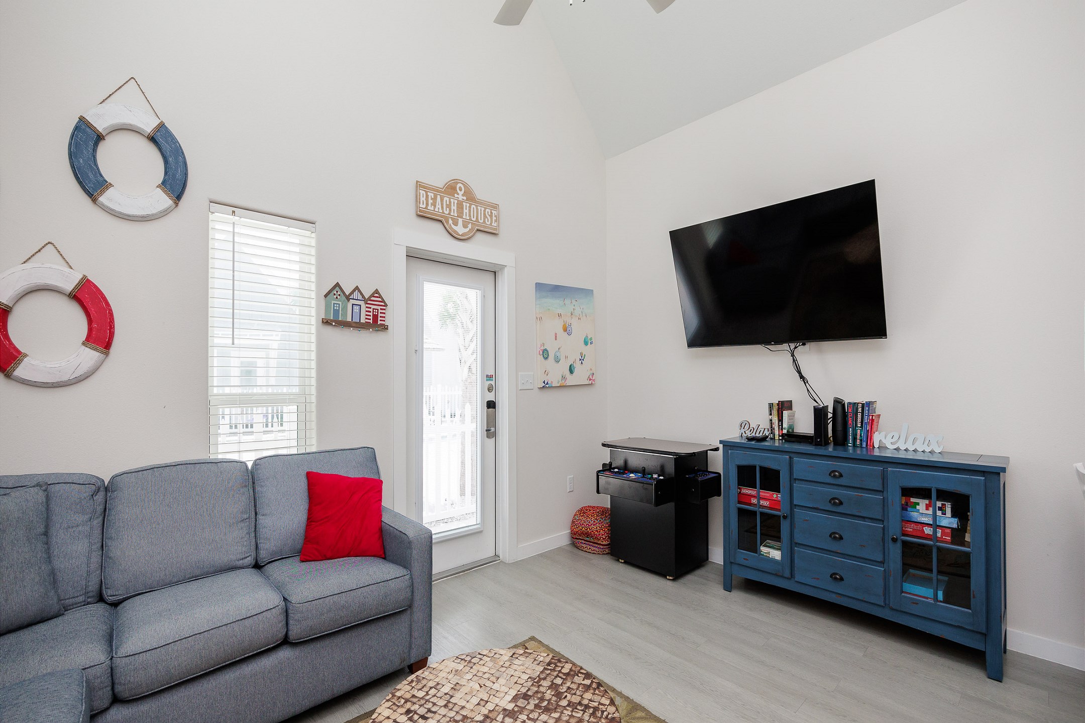 Cozy living area with a flat-screen TV and an arcade game for endless fun