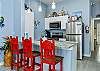 Dining area with modern appliances and three bar stools for entertaining 