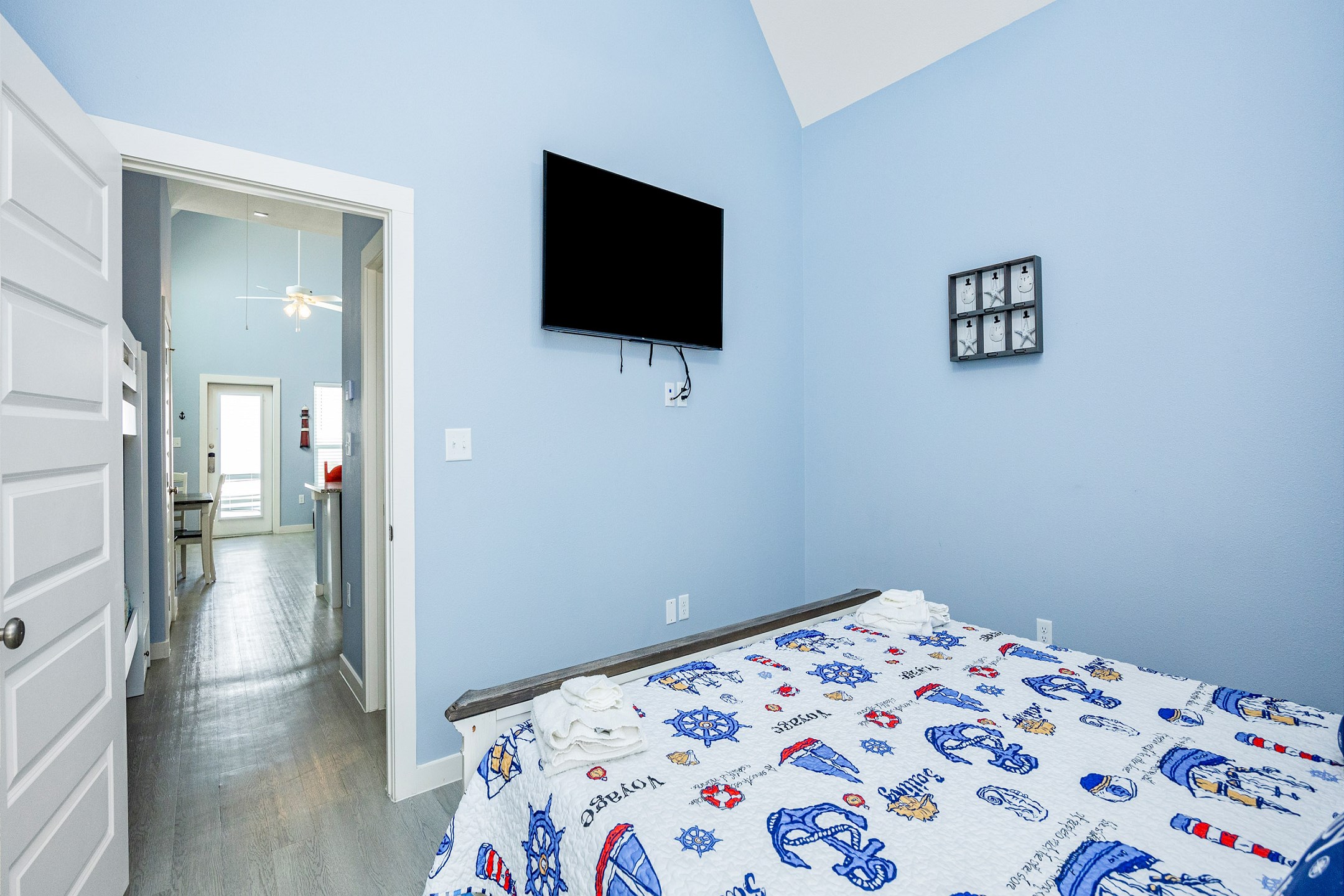 Master bedroom with king size bed, access to private patio, and a flat screen TV