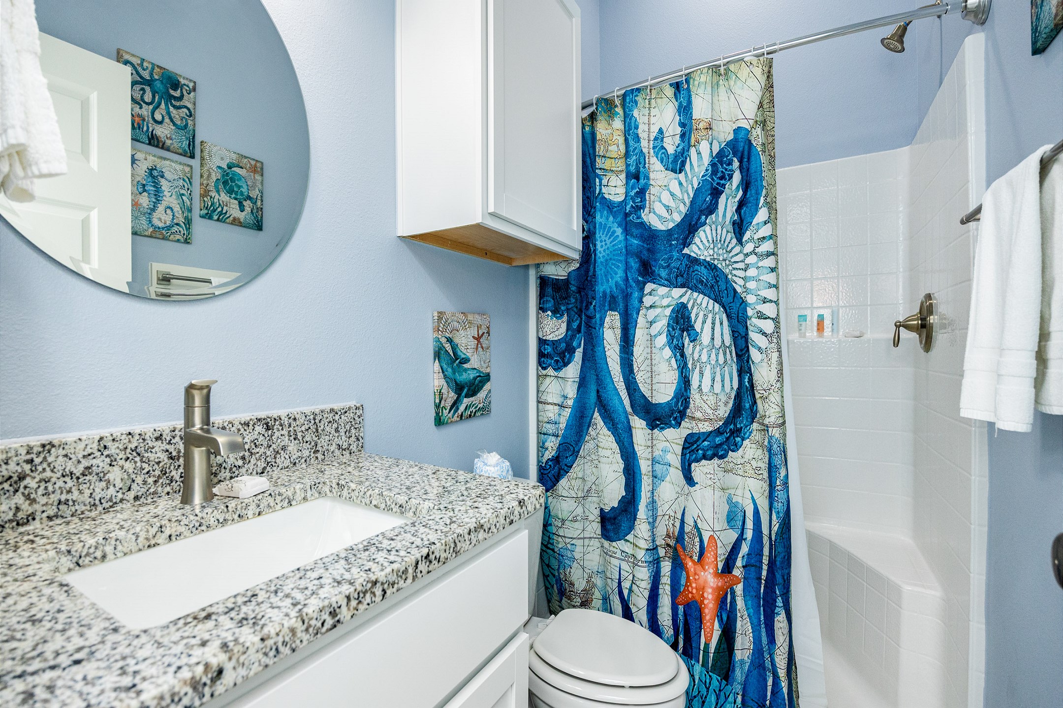 Shared, guest bathroom with sink and walk-in shower