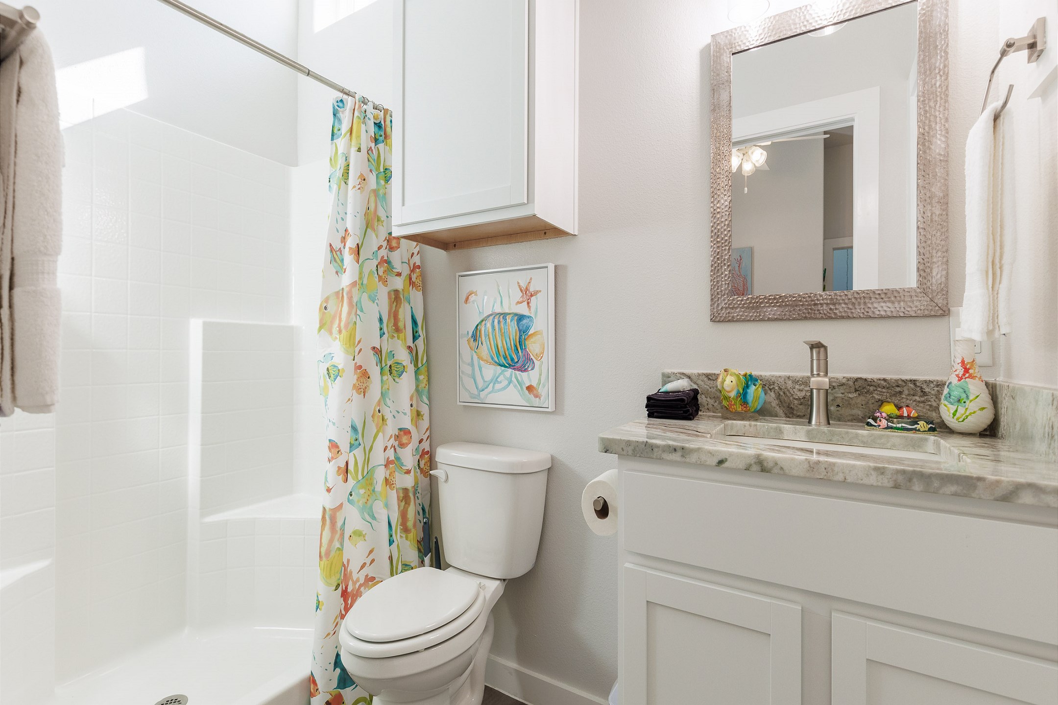 Master bathroom featuring bright, cheerful decor and a refreshing walk-in shower