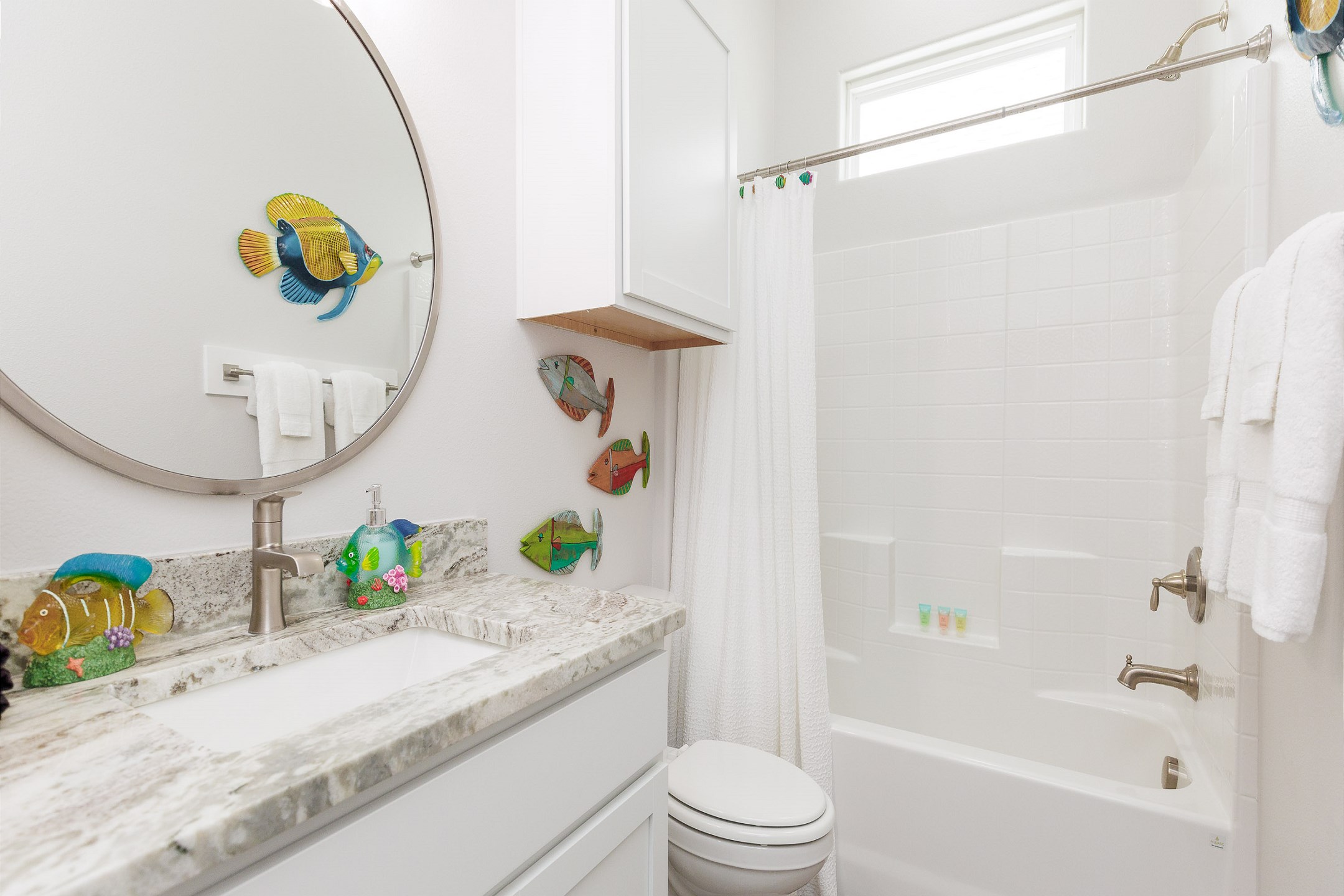 Guest bathroom off hallway with tub/shower combo 