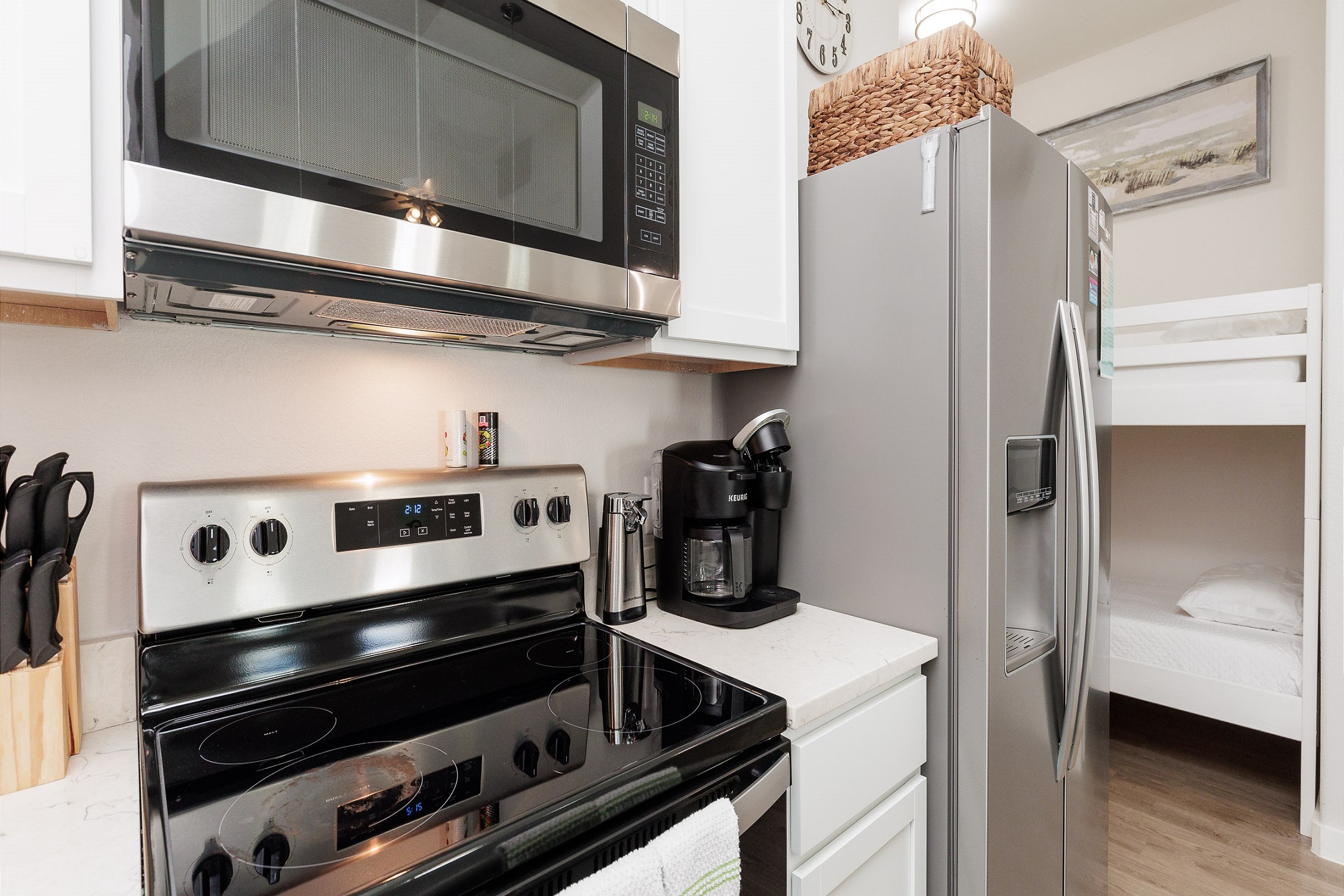 Coffee maker, toaster, cookware, dinnerware, and other kitchen essentials provided