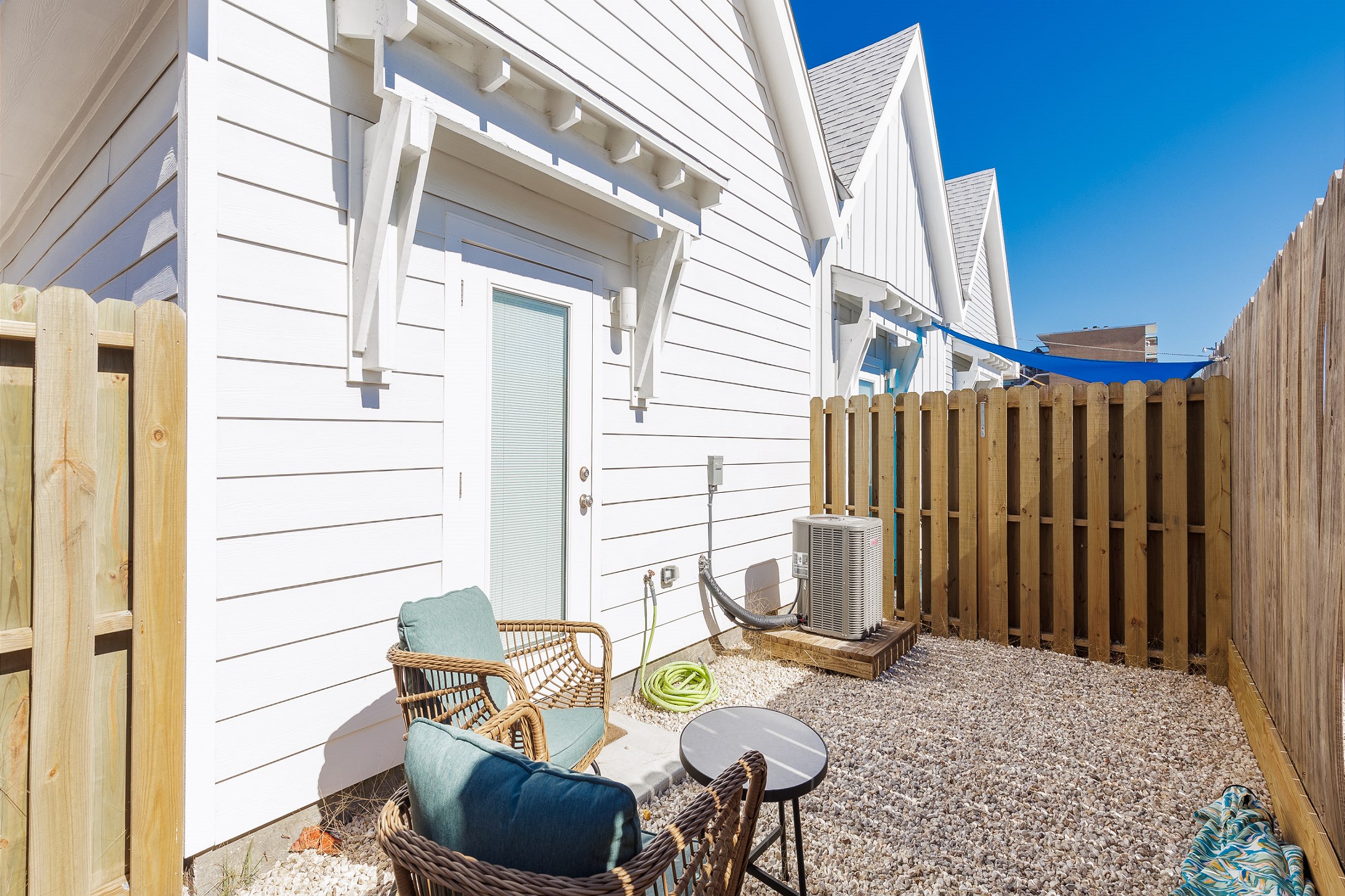 Back patio area with comfortable seating and lots of privacy 