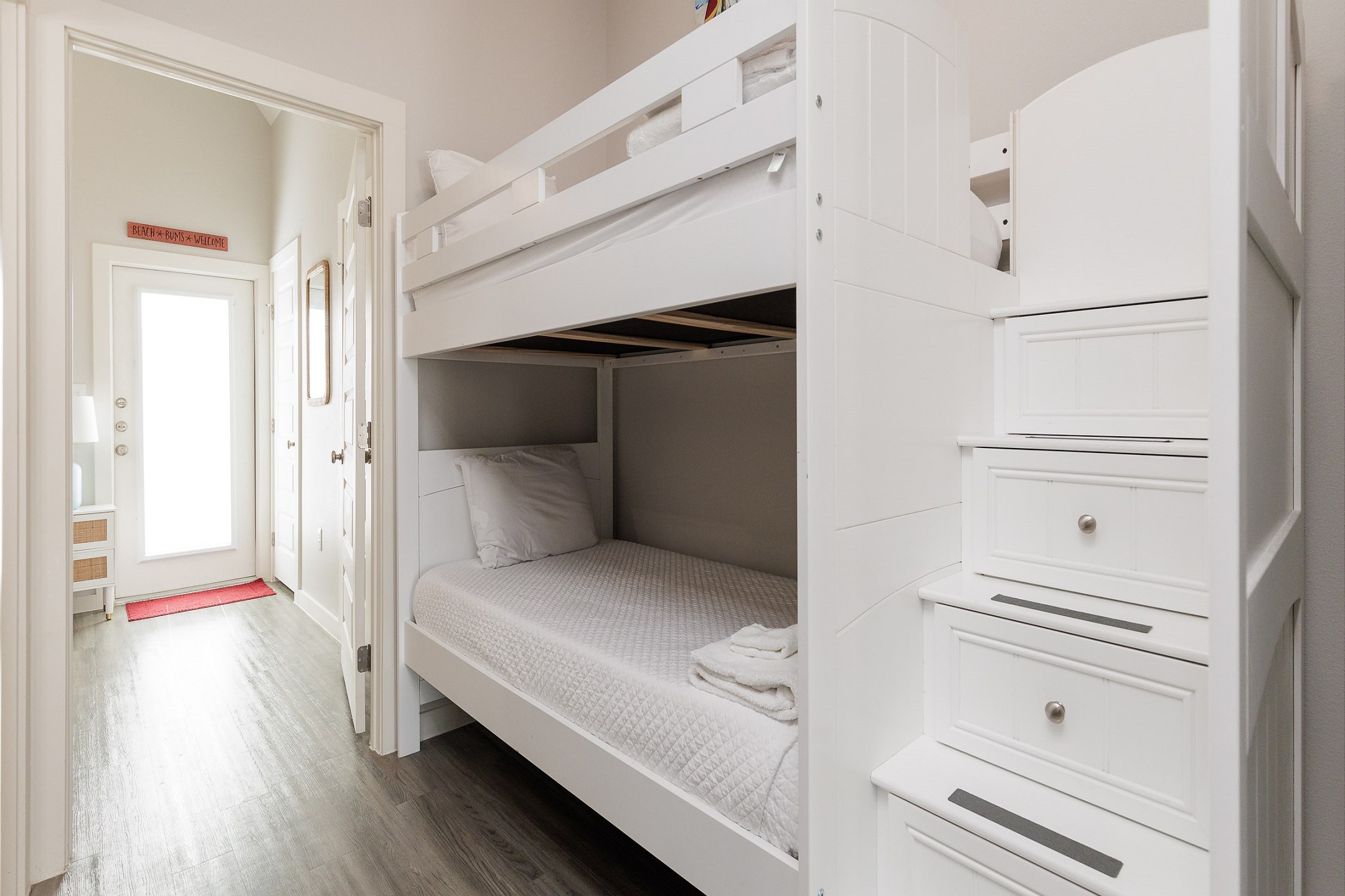 Twin over twin size bunk bed tucked away in hallway nook 