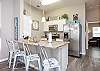 Fully equipped kitchen with stainless steel appliances and breakfast bar that seats three 