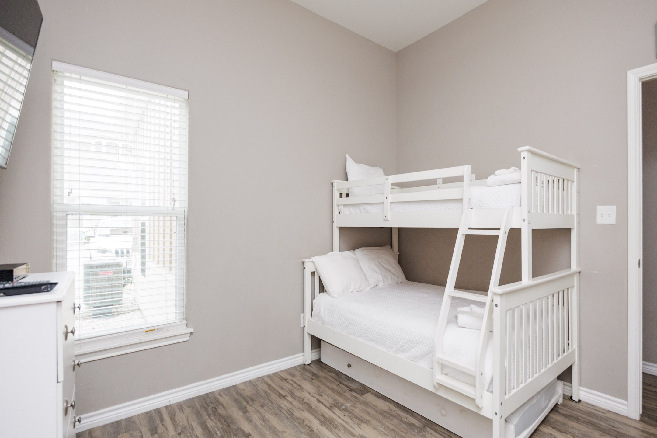 Second bedroom with twin over full bunk bed and a twin trundle, along with a twin over twin bunk bed with a twin trundle - offering a flat screen TV