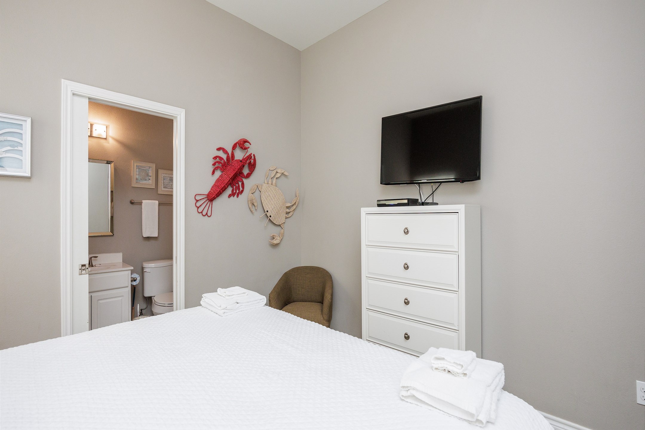 Master bedroom with a king size bed, private bathroom, and flat screen TV