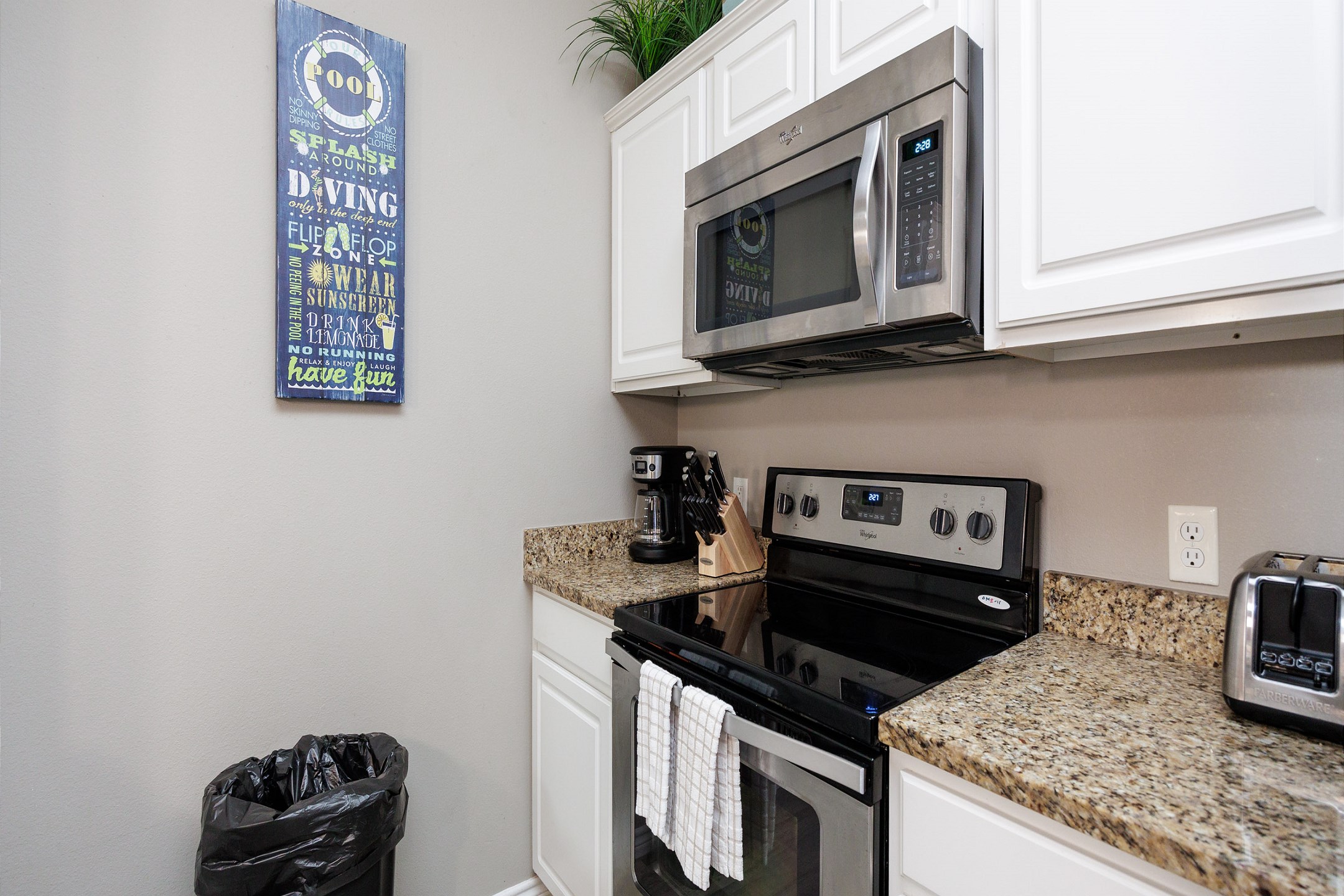 Coffee maker, toaster, cookware, dinnerware, and other kitchen essentials provided