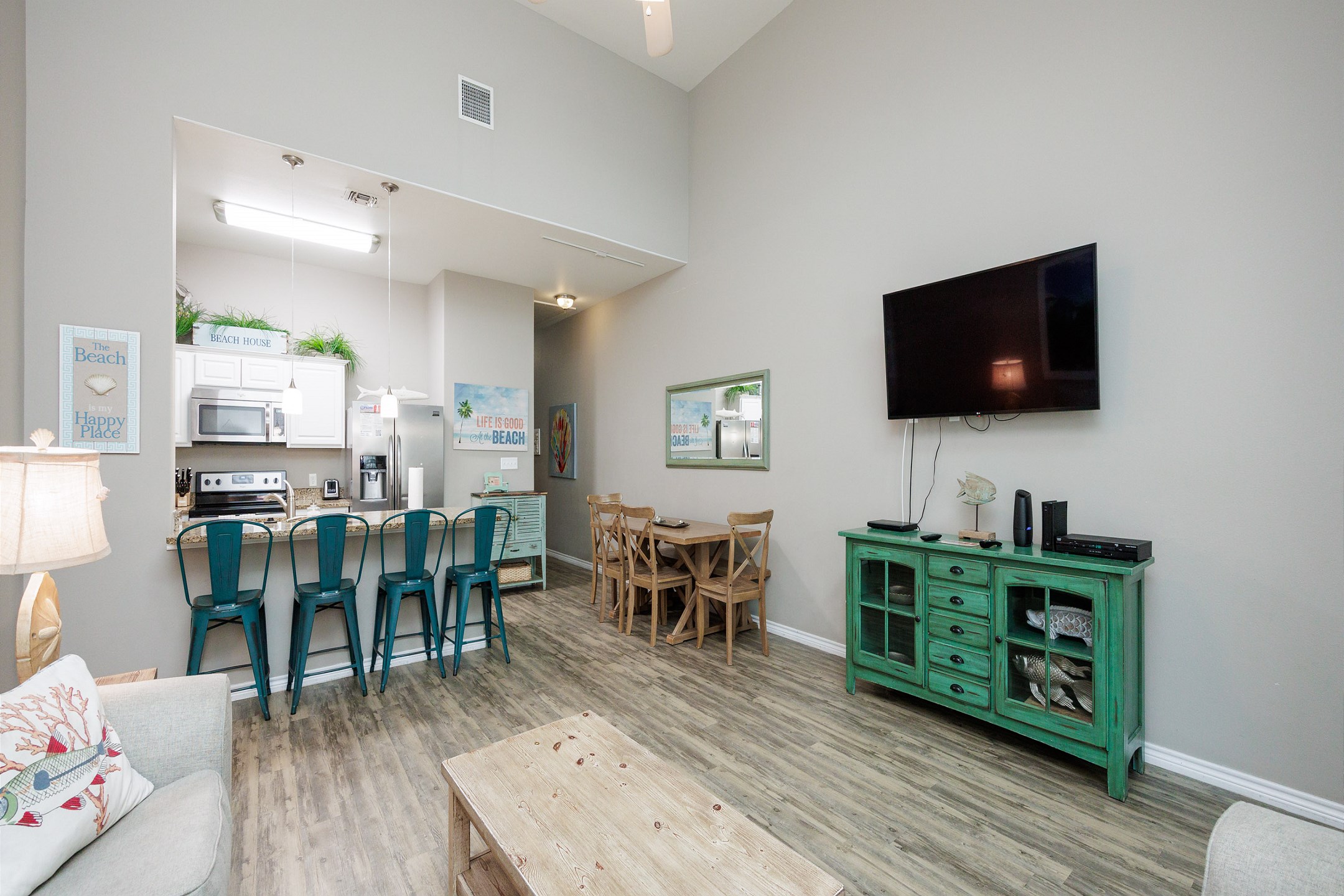Open-concept living area with high ceilings, flooded with natural light and providing the perfect ambiance for unwinding after a day of adventures