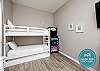 Second bedroom with twin over full size bunk bed with twin trundle and twin over twin size bunk bed with twin trundle, along with flat screen TV