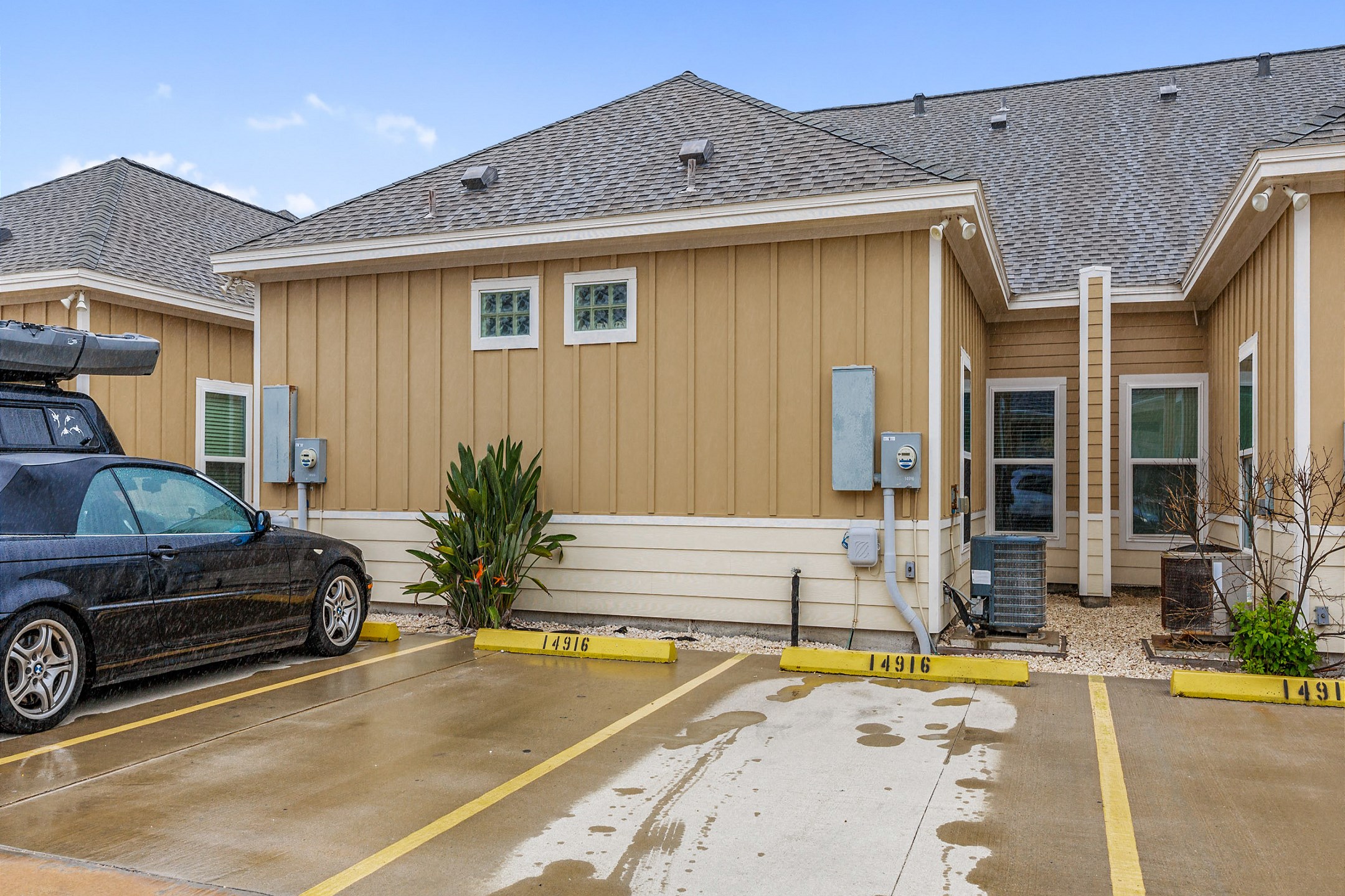 Exterior of property including two reserved parking spots