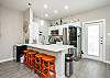 Fully stocked kitchen with barstools and coffee maker