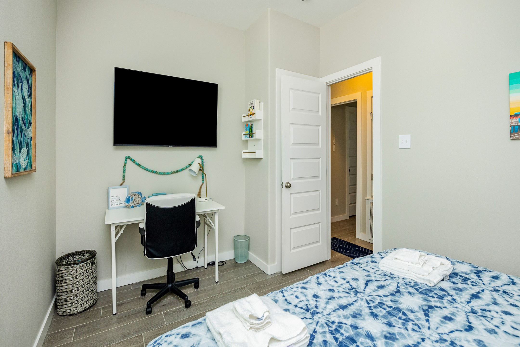 The second-floor guest bedroom features a comfortable king-size bed and a desk for those quiet moments. Perfect for relaxing after a day of adventure or catching up on a little vacation work.