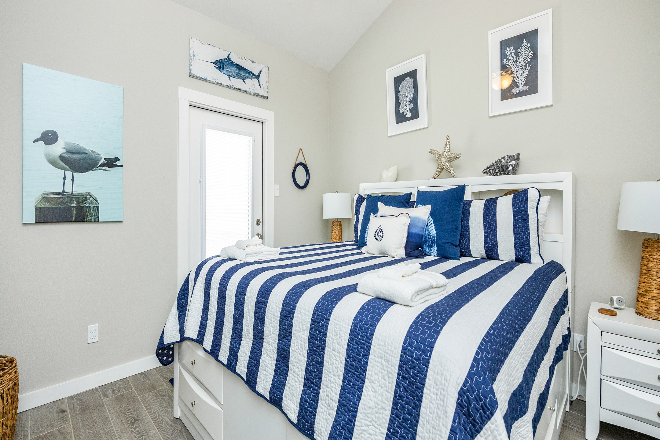 The additional second-floor guest bedroom offers a king-size bed, flat-screen TV, and access to a private patio—your perfect retreat for relaxing, watching a movie, or enjoying the fresh air after a day of vacation adventures.