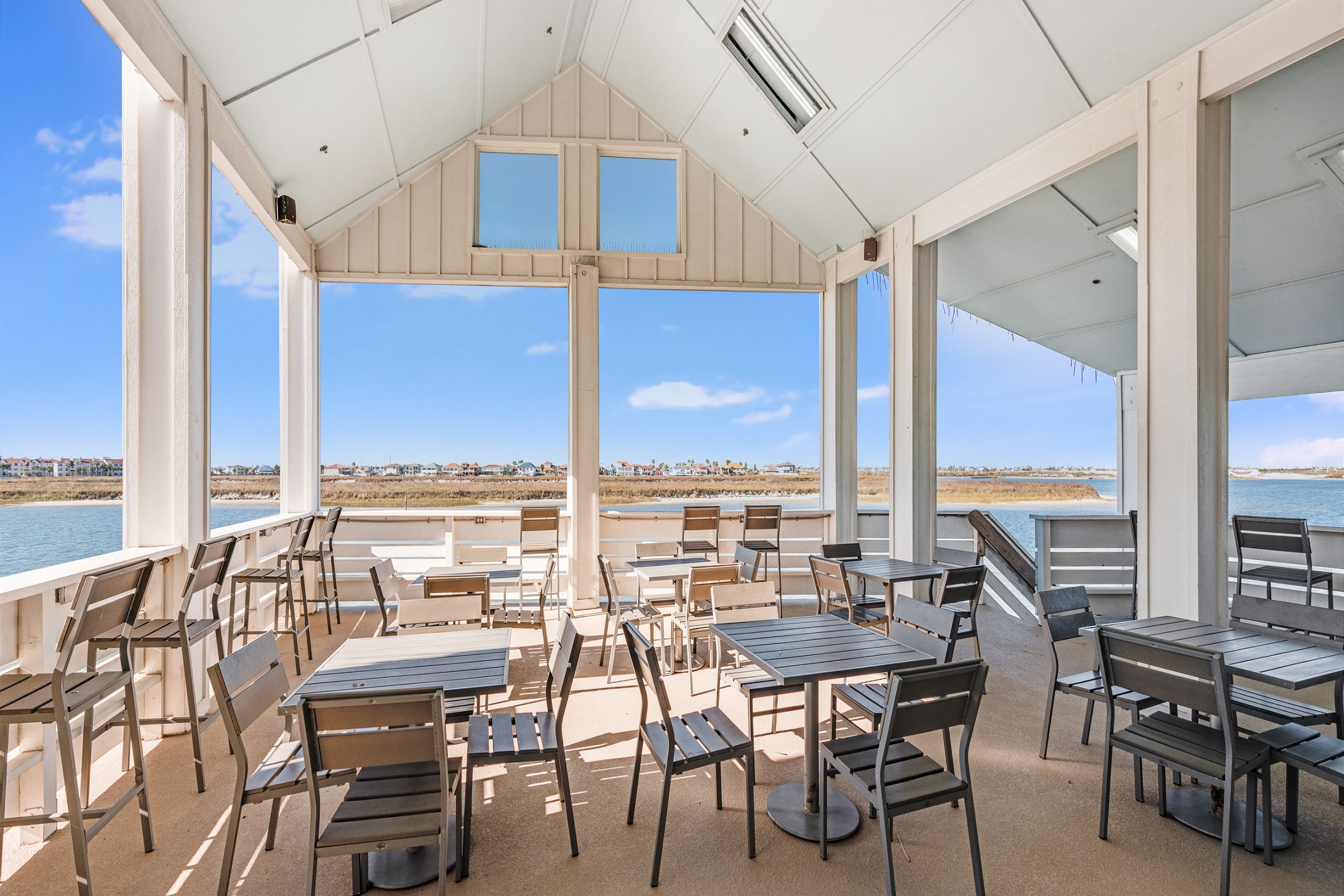 Waterfront oasis at Kokomo Yacht Club! Unwind on the second-floor deck, overlooking the canal and pool—your perfect retreat to enjoy peaceful views and the relaxing atmosphere.