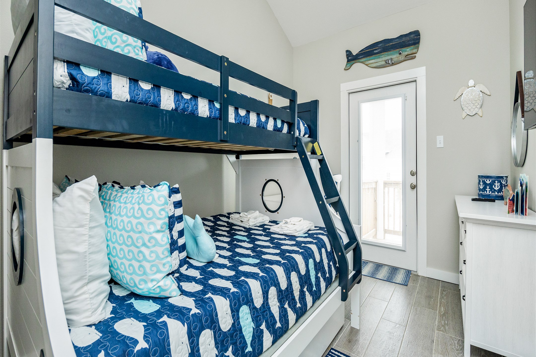 The charming fourth bedroom is all about sleepover vibes, with a twin-over-full bunk bed and a twin trundle bed—perfect for kids or friends to gather, relax, and make lasting vacation memories after a day of adventure!