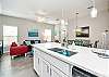 Bright kitchen Island with beautiful white granite counter tops 