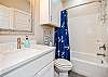 Guest bathroom on the second floor with single sink and tub/shower combo