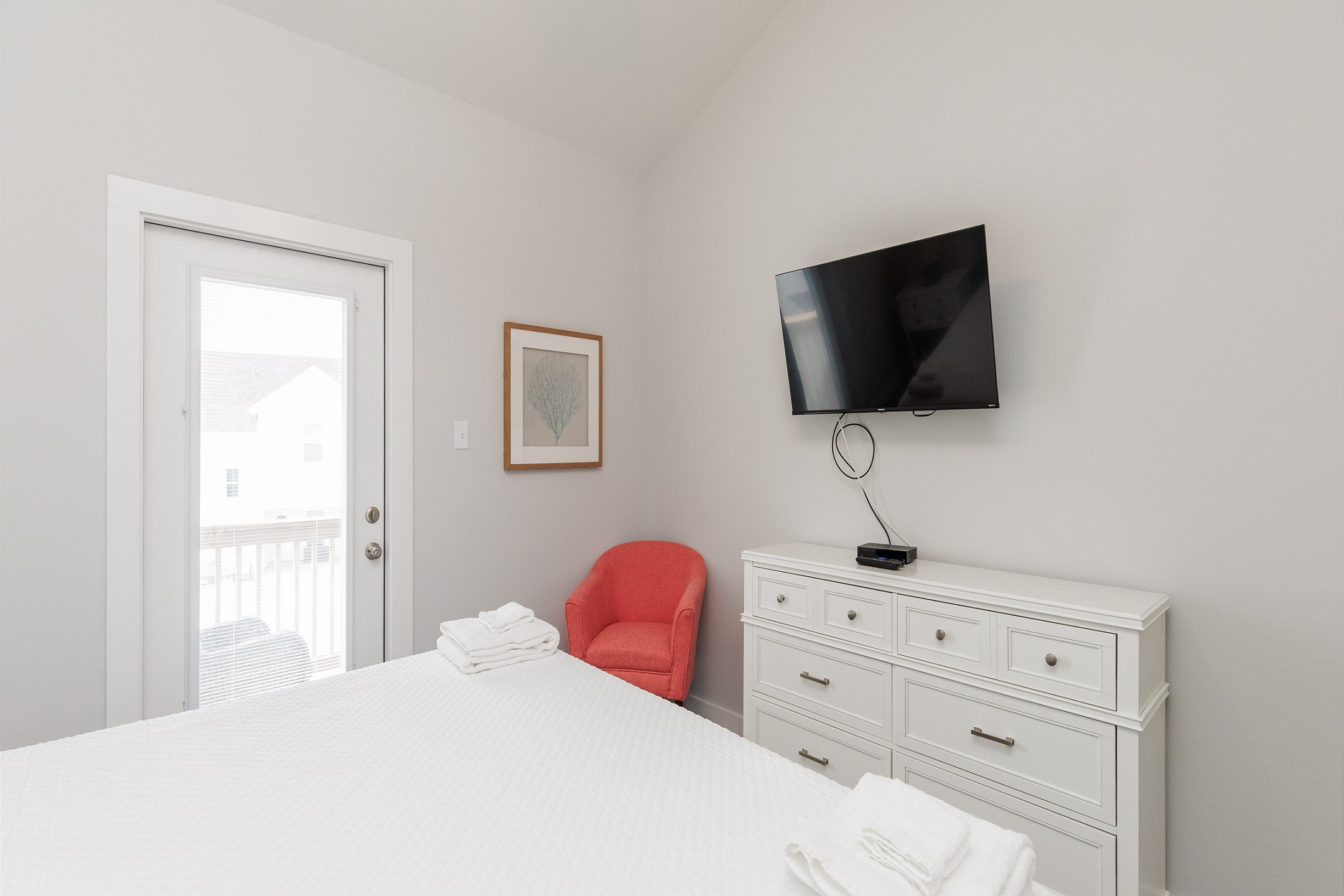 Second bedroom on the second floor with king size bed, private bathroom, balcony access and flat screen TV