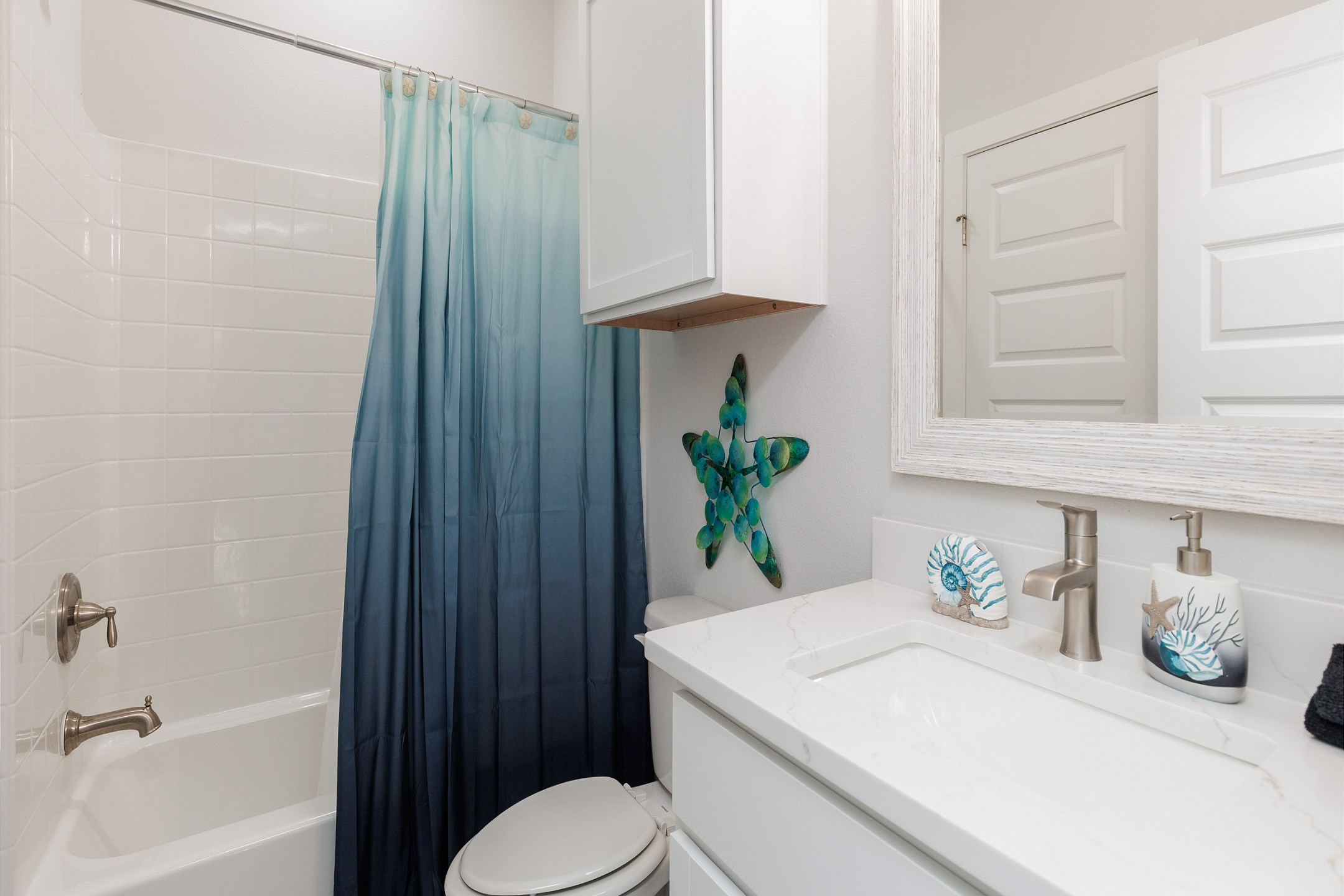 Guest bathroom on the second floor with single sink and tub/shower combo 