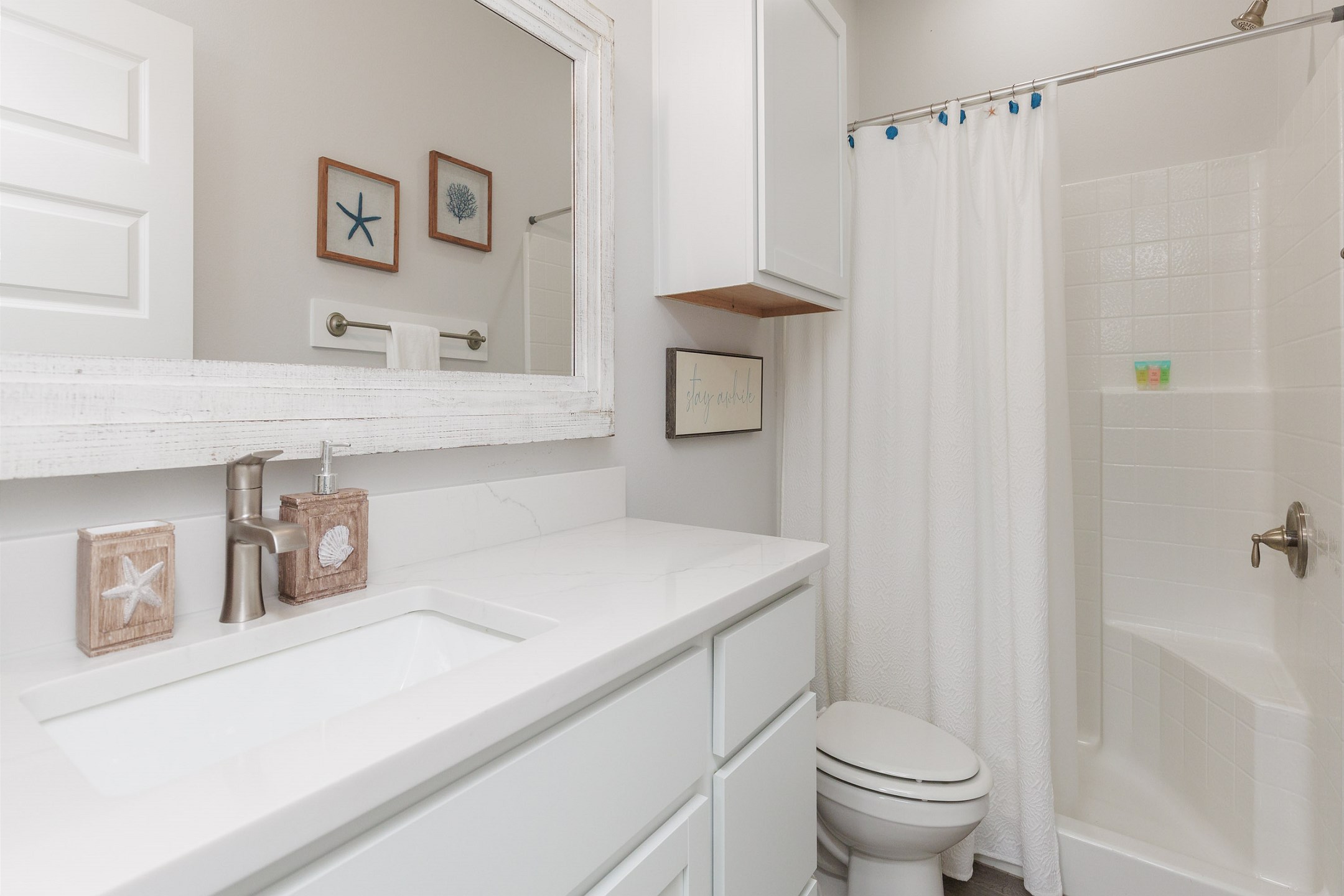 Guest bathroom on the first floor with single sink and walk in shower