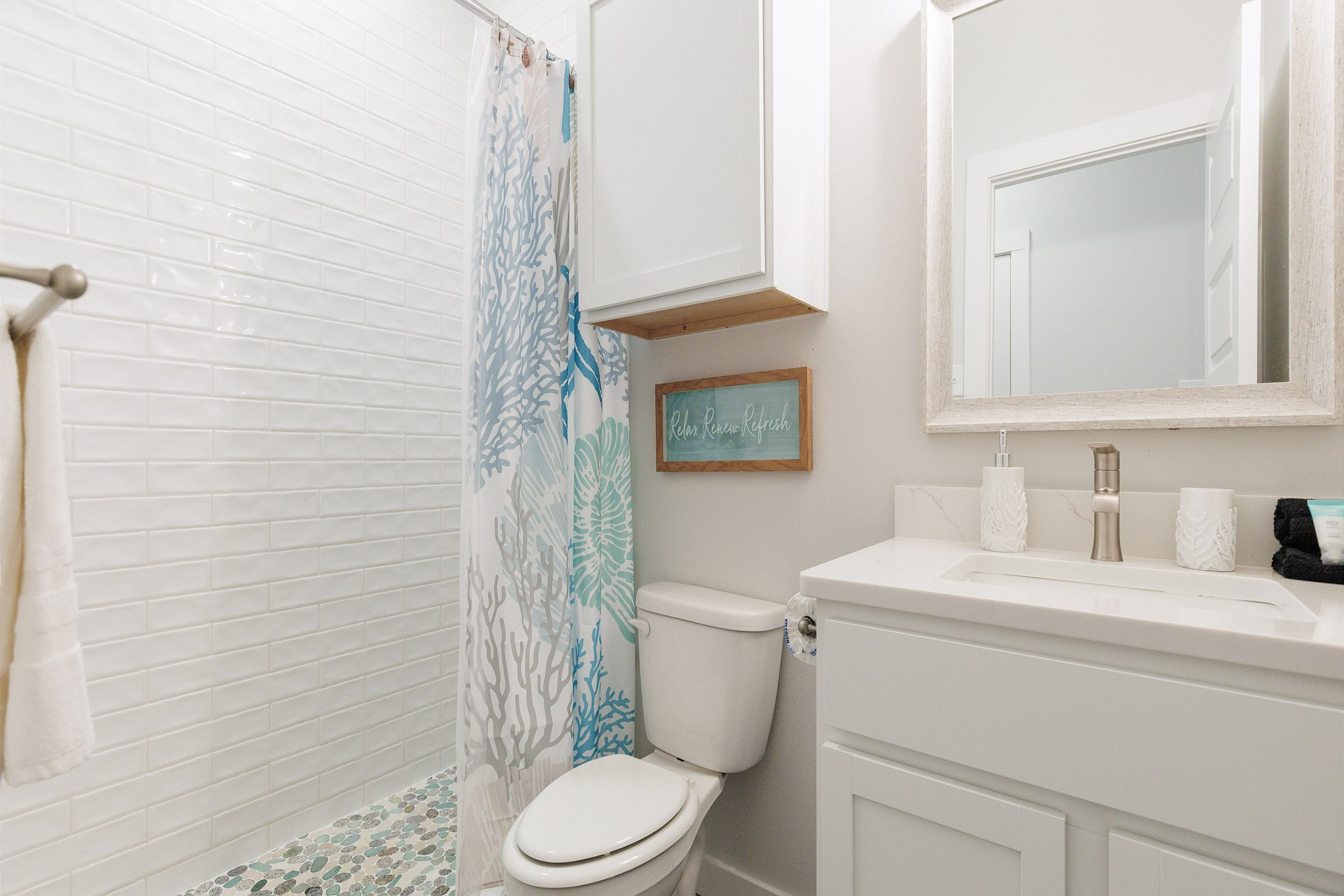 Attached bathroom off the second bedroom with single sink and walk in shower