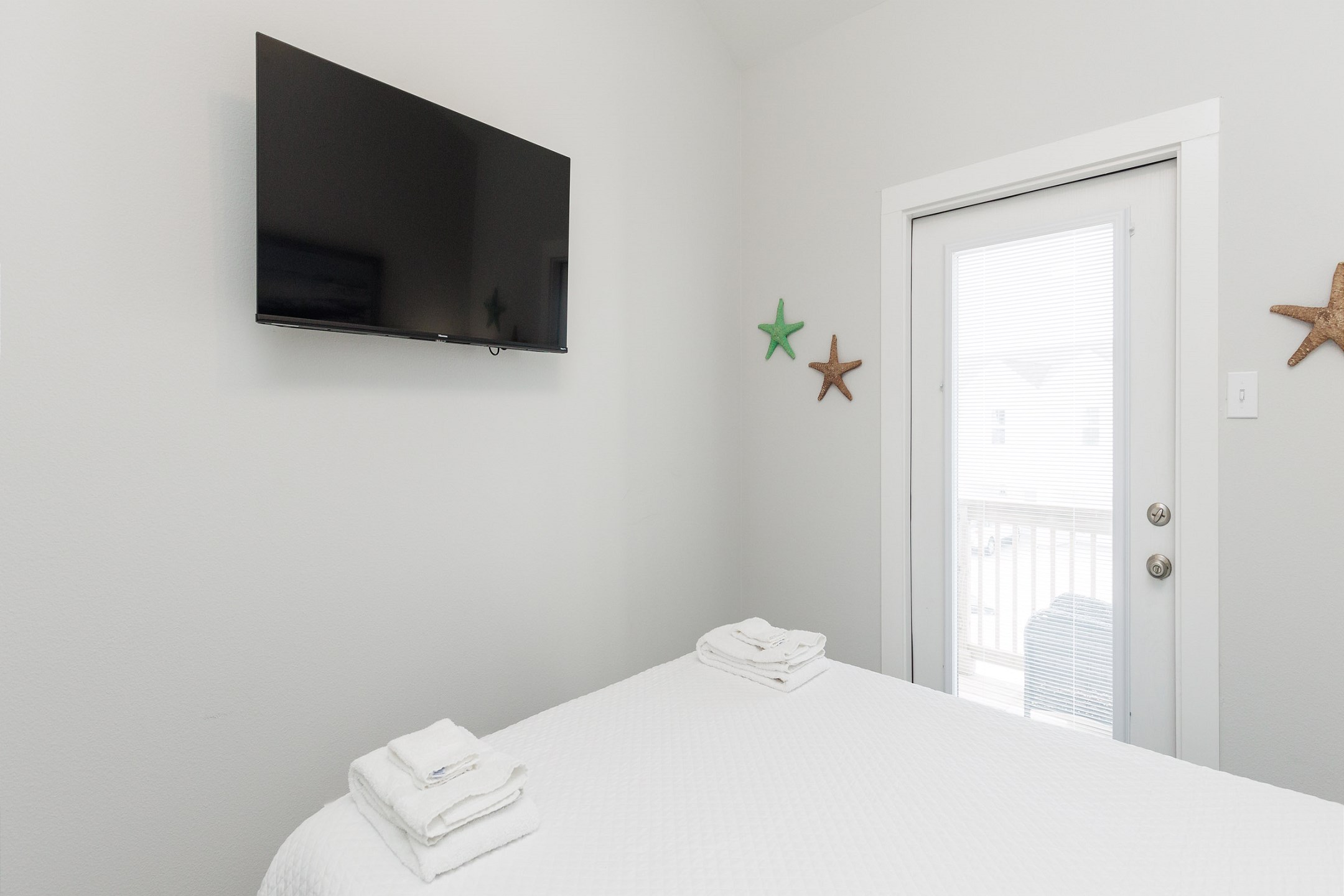 Third bedroom on the second floor with queen size bed, balcony access and flat screen TV