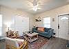 Living area with queen size murphy bed, flat screen TV, and plenty of natural lighting 