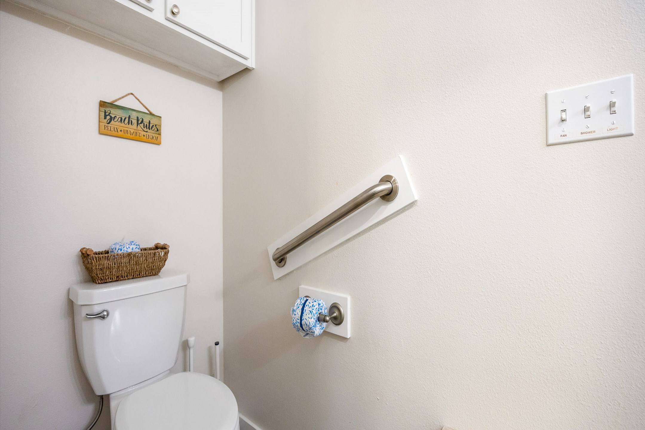 Guest bathroom on the first floor with walk-in shower that offers railing