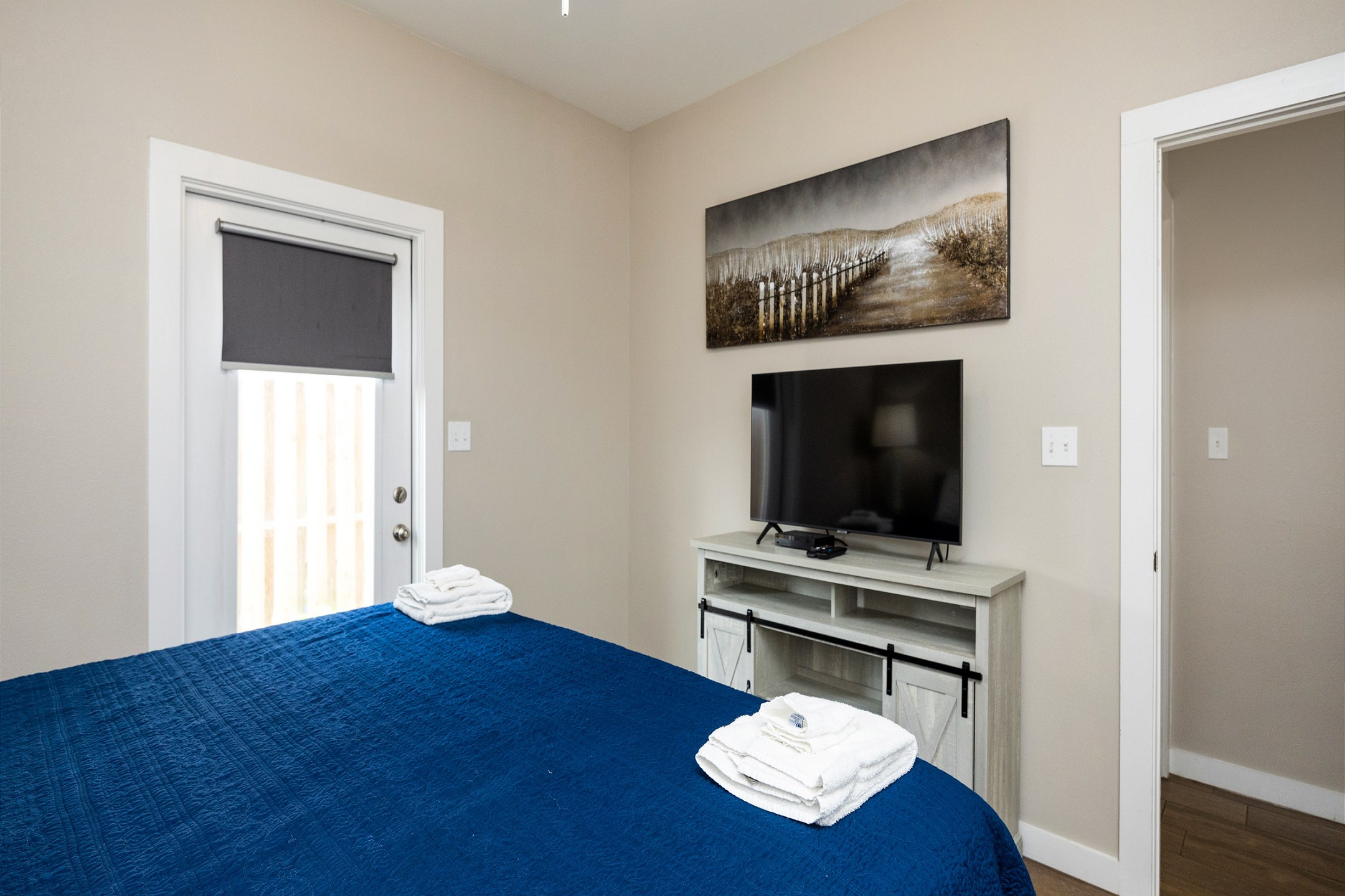 Master bedroom with king size bed, access to patio and flat screen TV 