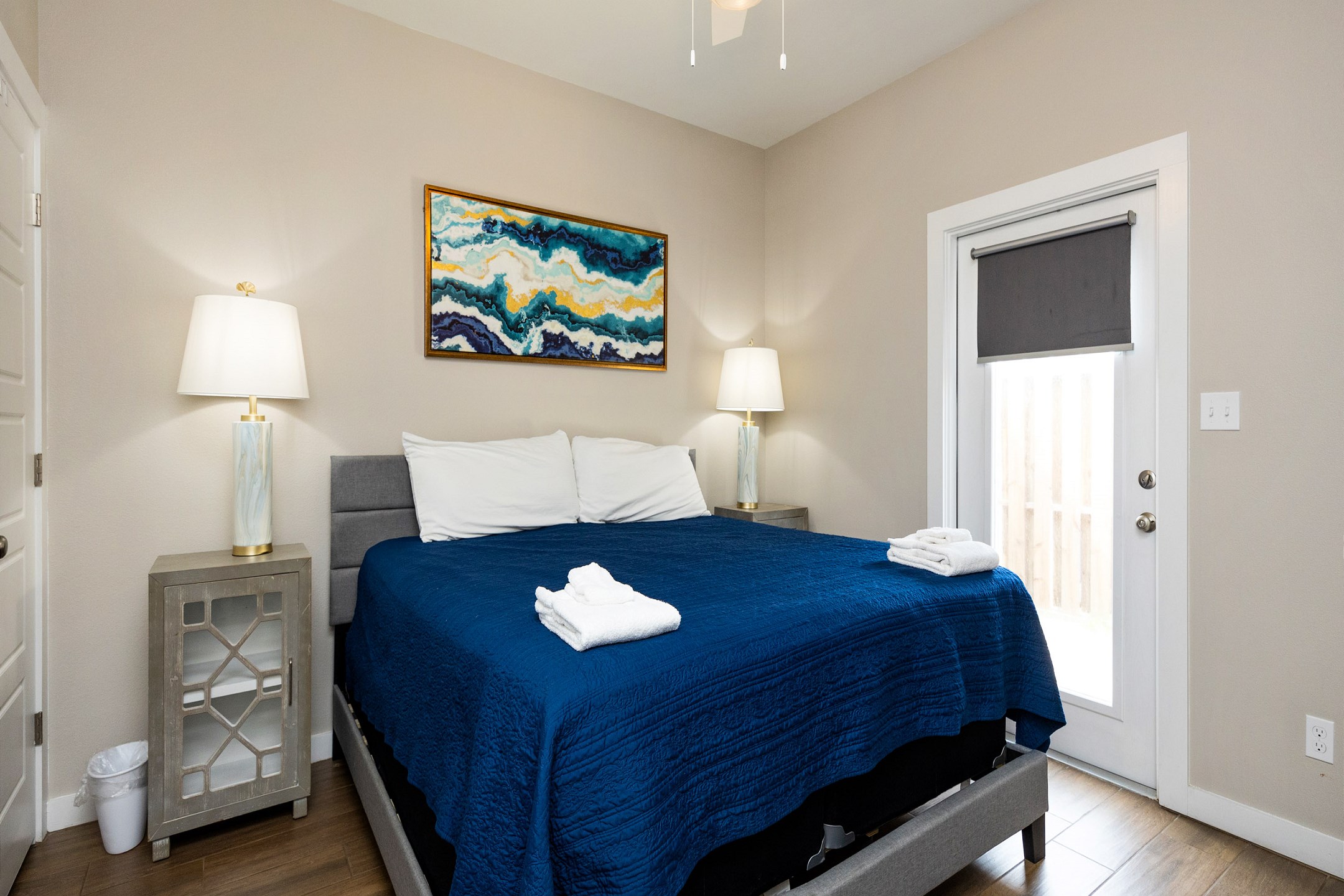 Master bedroom with king size bed, access to patio and flat screen TV 