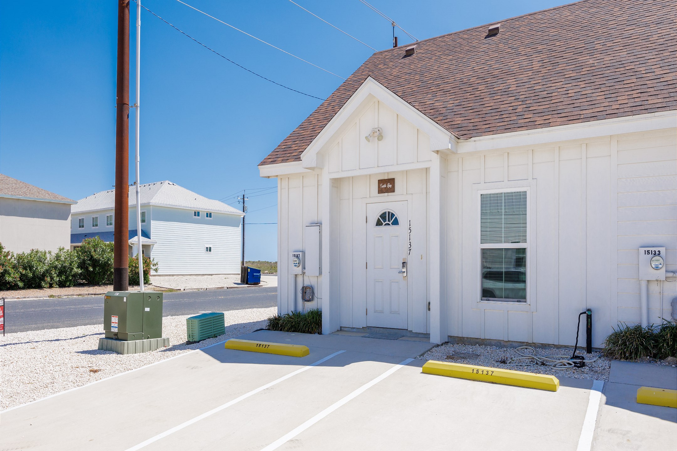 Front of property with two reserved parking spots