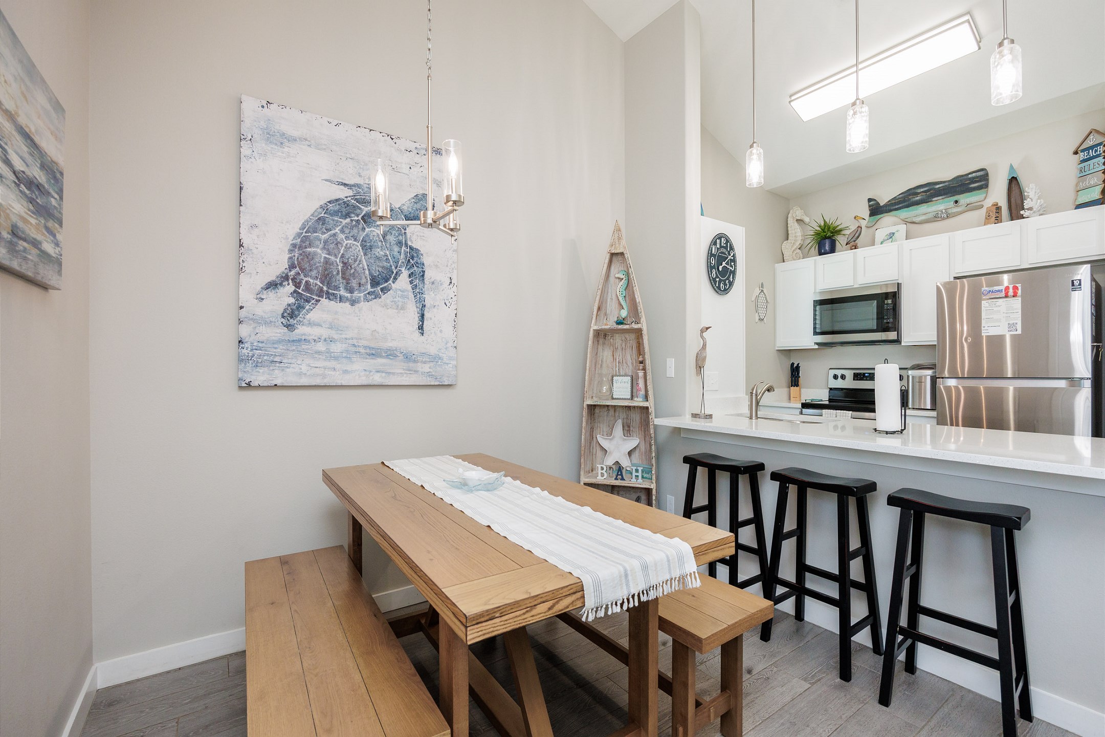 Dining table, breakfast bar, and well-equipped kitchen