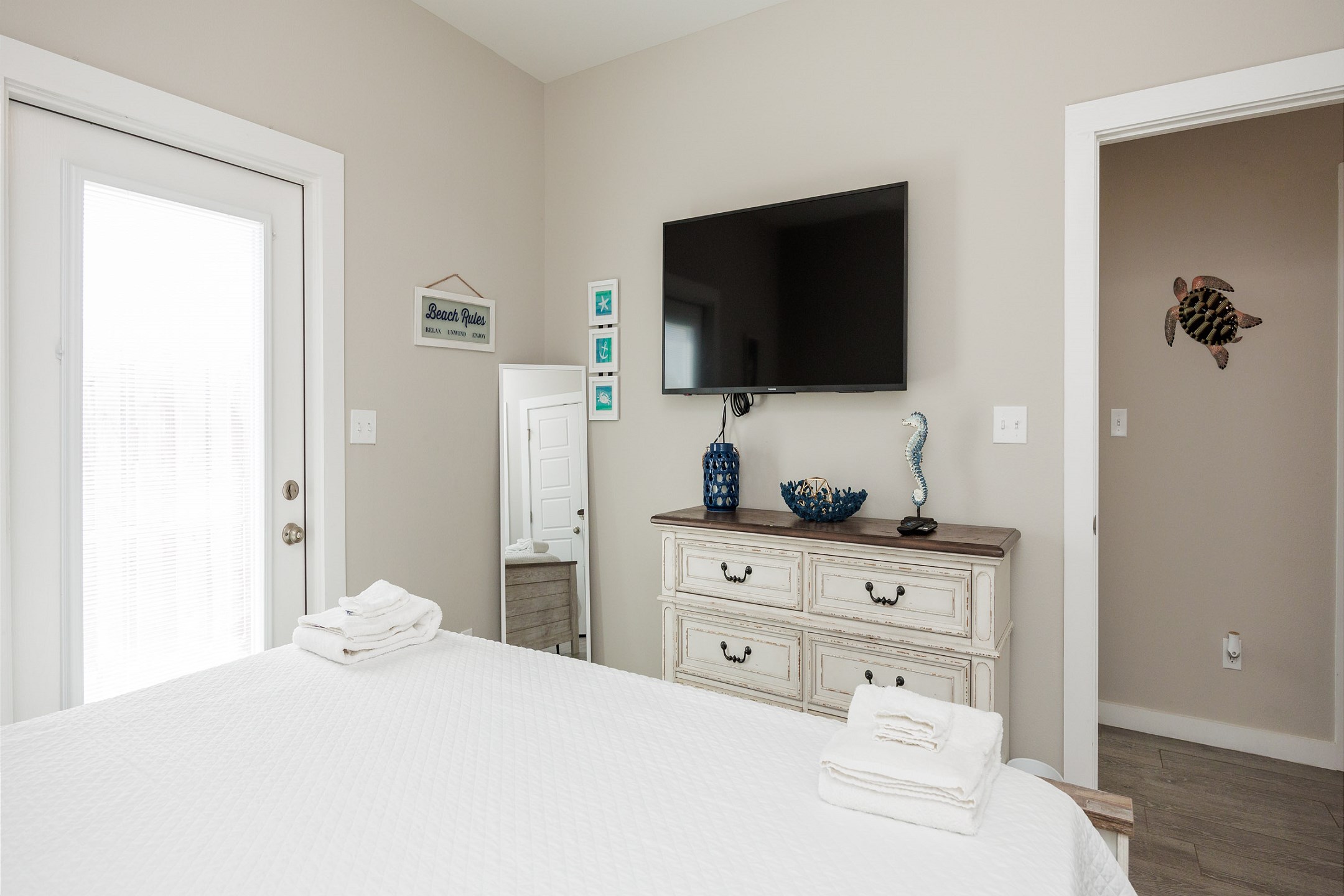 Master bedroom with king size bed, access to the patio and flat screen TV