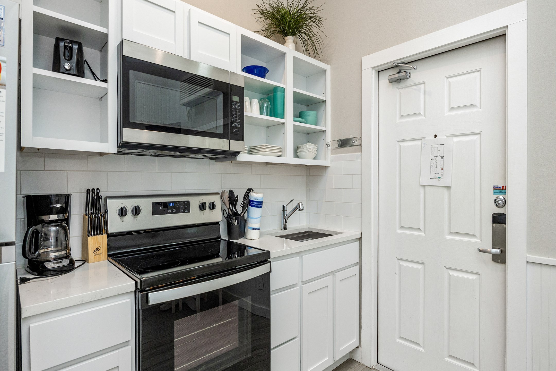 Kitchen area with full cup coffee maker 